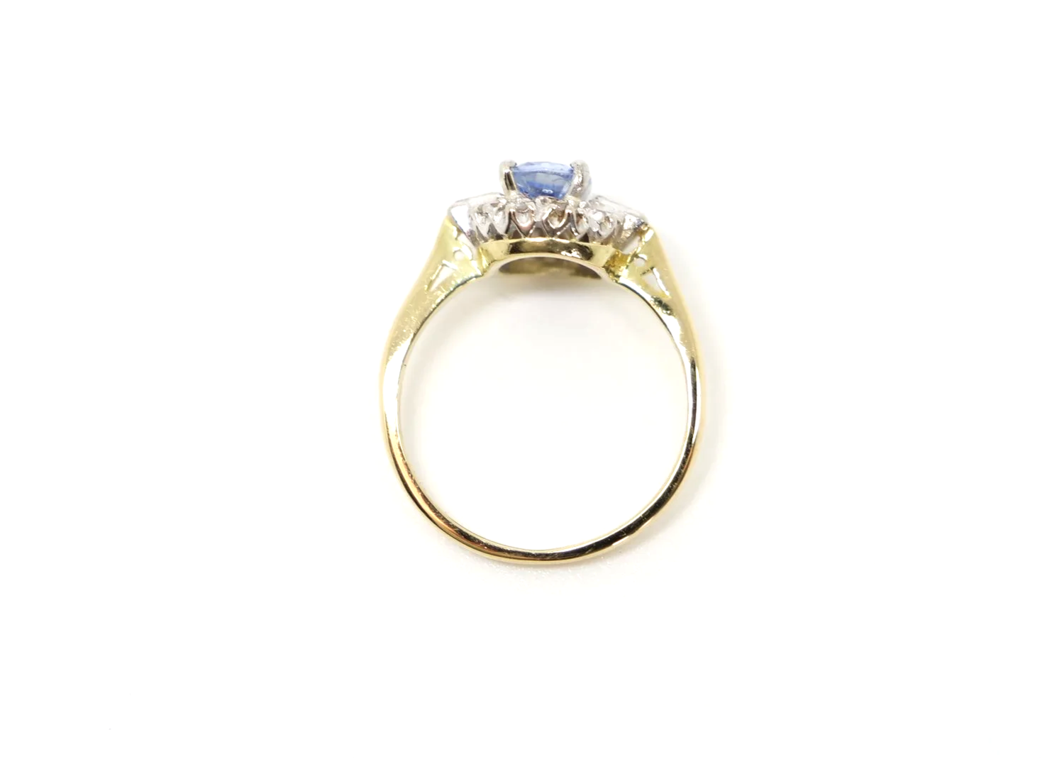 Stunning 18ct gold sapphire and diamond ring, set with an oval light blue sapphire and surrounded by diamonds, with a baguette diamond to each shoulder.