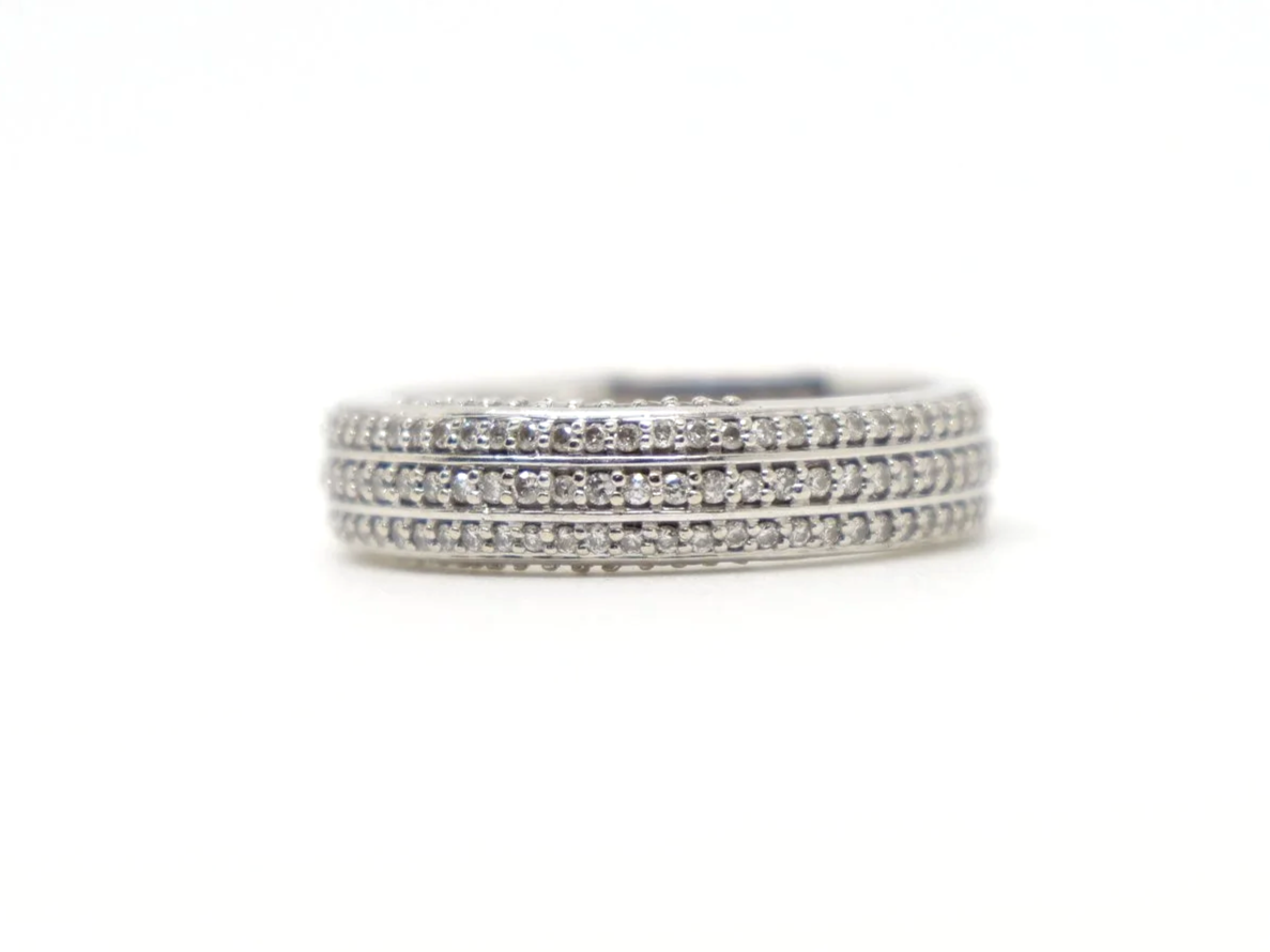 Contemporary 18ct gold triple row diamond three quarter eternity ring, with three rows of diamonds and further diamonds in both top and bottom of setting.