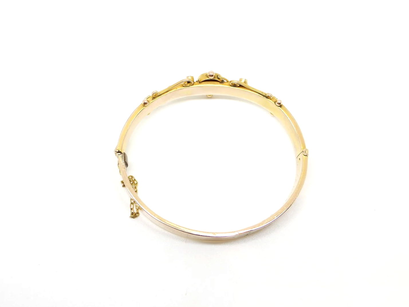 Antique 1907 9ct gold hinged bangle with central star-set sapphire and seed pearl scrollwork