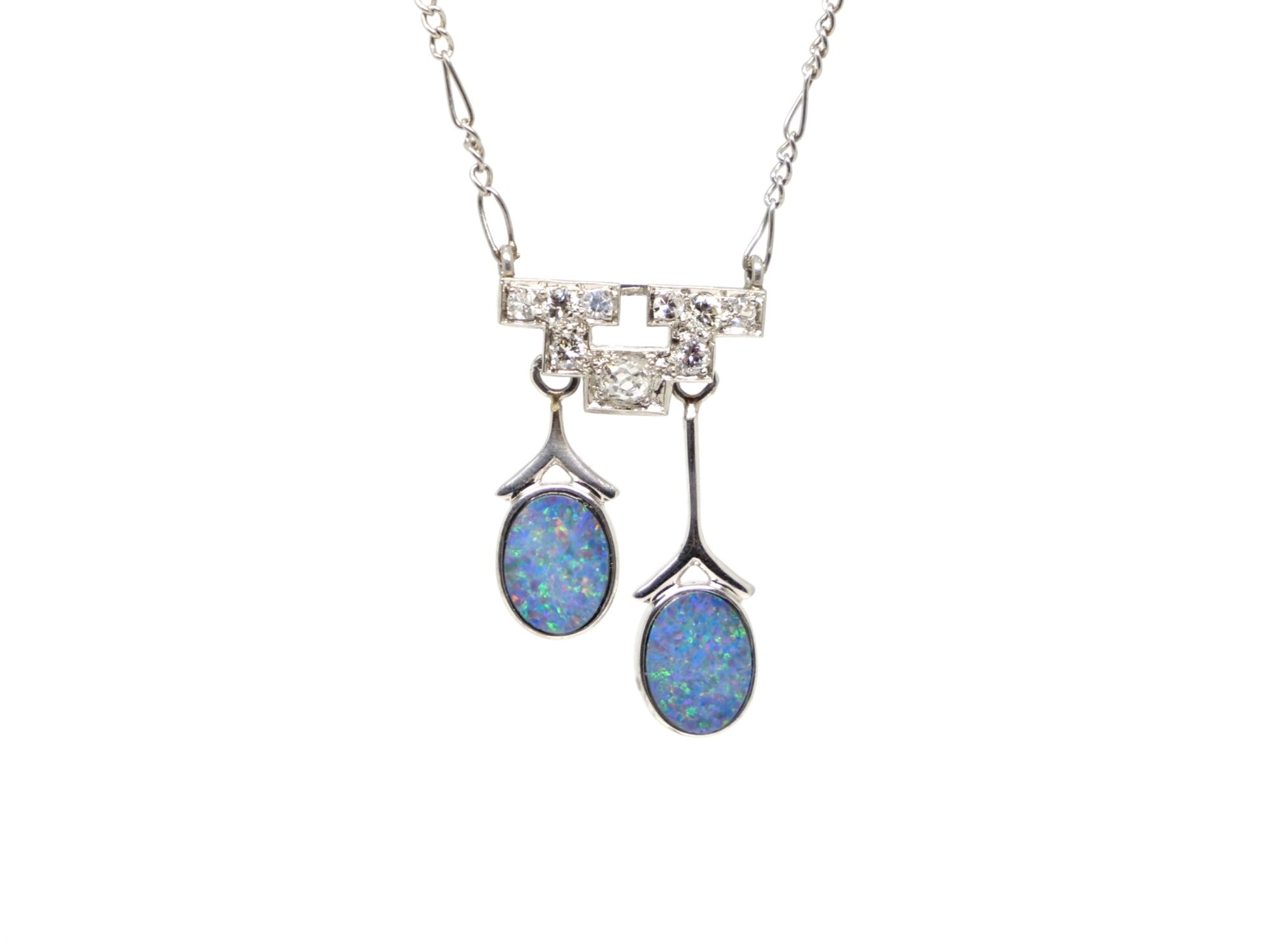 Stunning Art Deco platinum necklace, set with two drop opals and a geometric design set with old cut diamonds.