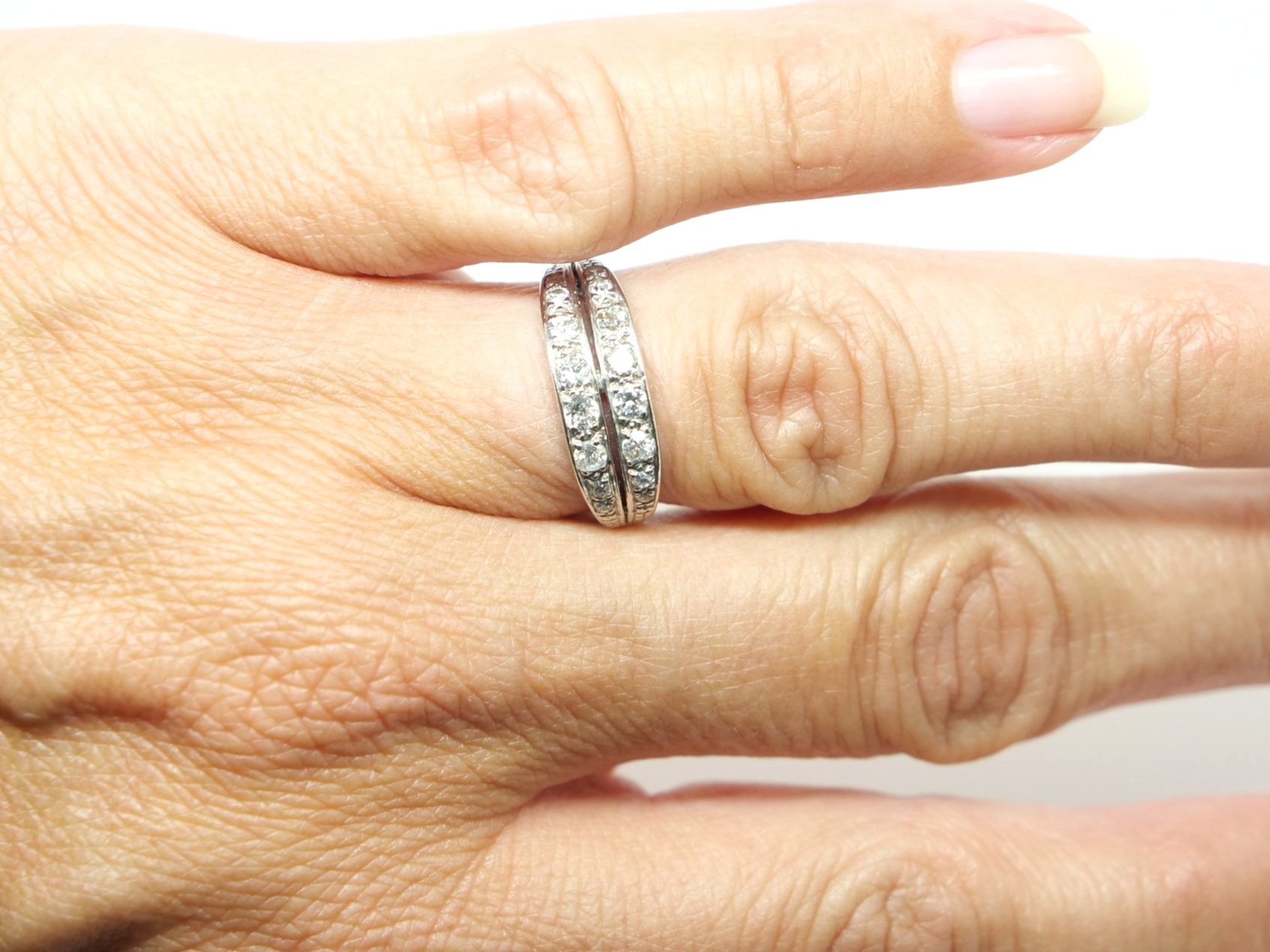 Lovely unusual Art Deco diamond ring in 14ct gold in a stylish double band design. Each band is set with eight old cut diamonds that graduate down in size from the centre diamond outwards.