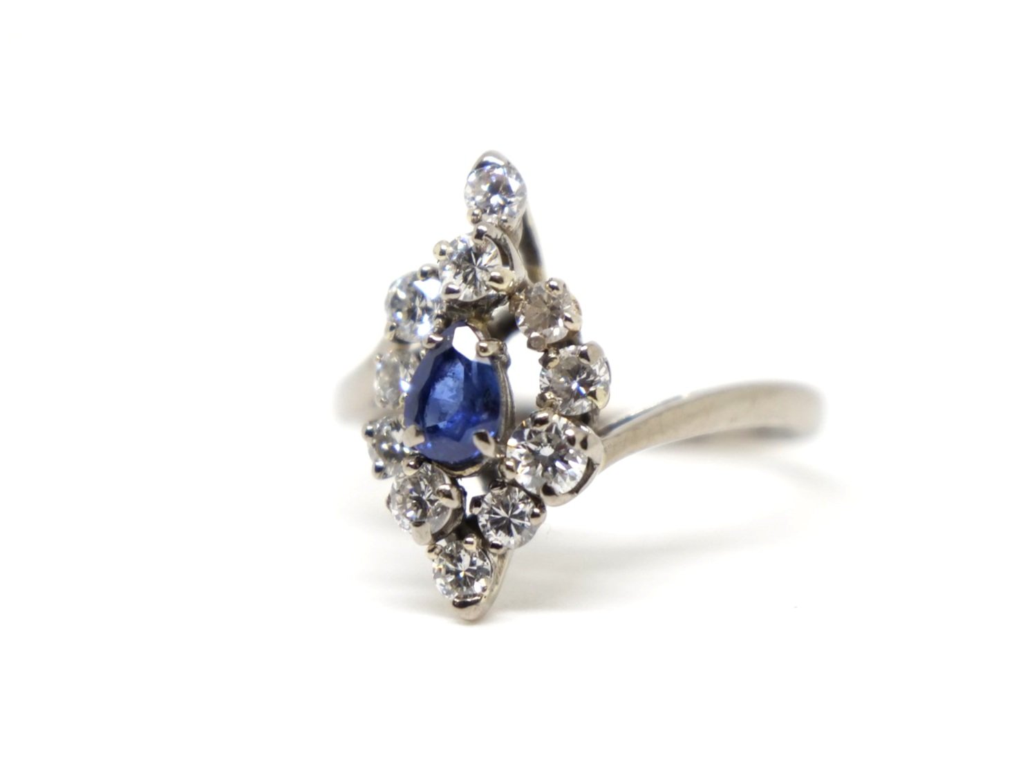 Unusual vintage 18ct gold sapphire and diamond cocktail ring, set with a central pear cut sapphire and surrounded by brilliant cut diamonds of different sizes.