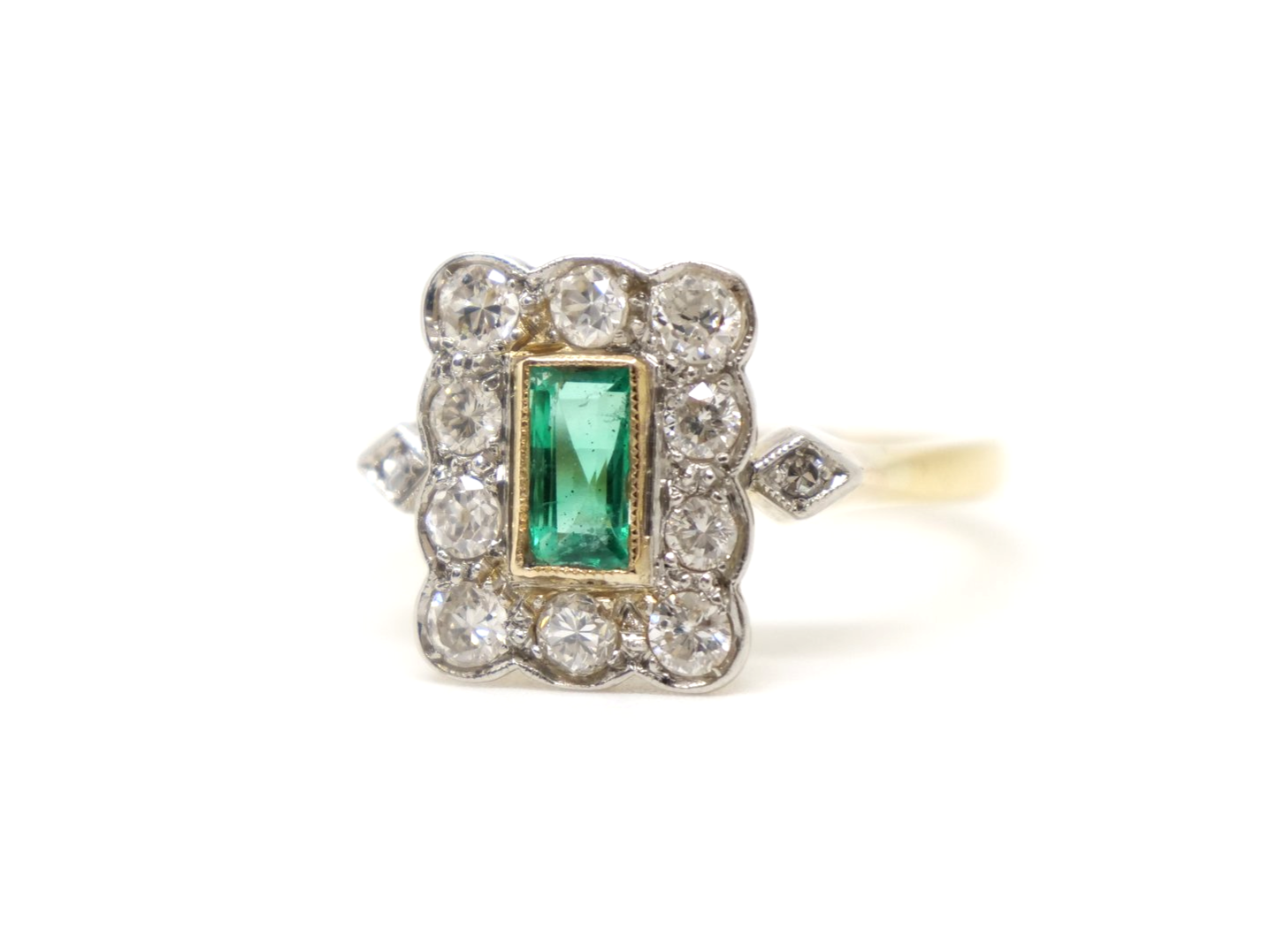 Very pretty vintage 18ct gold emerald and diamond ring, set with an emerald cut emerald and surrounded by diamonds.