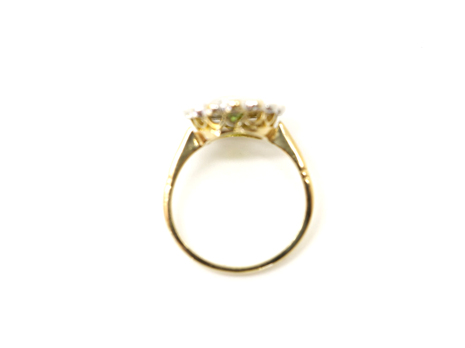 Superb vintage 18ct gold peridot and diamond ring, set with a 1.6ct oval cut peridot and surrounded by approximately 0.55cts of brilliant cut diamonds.