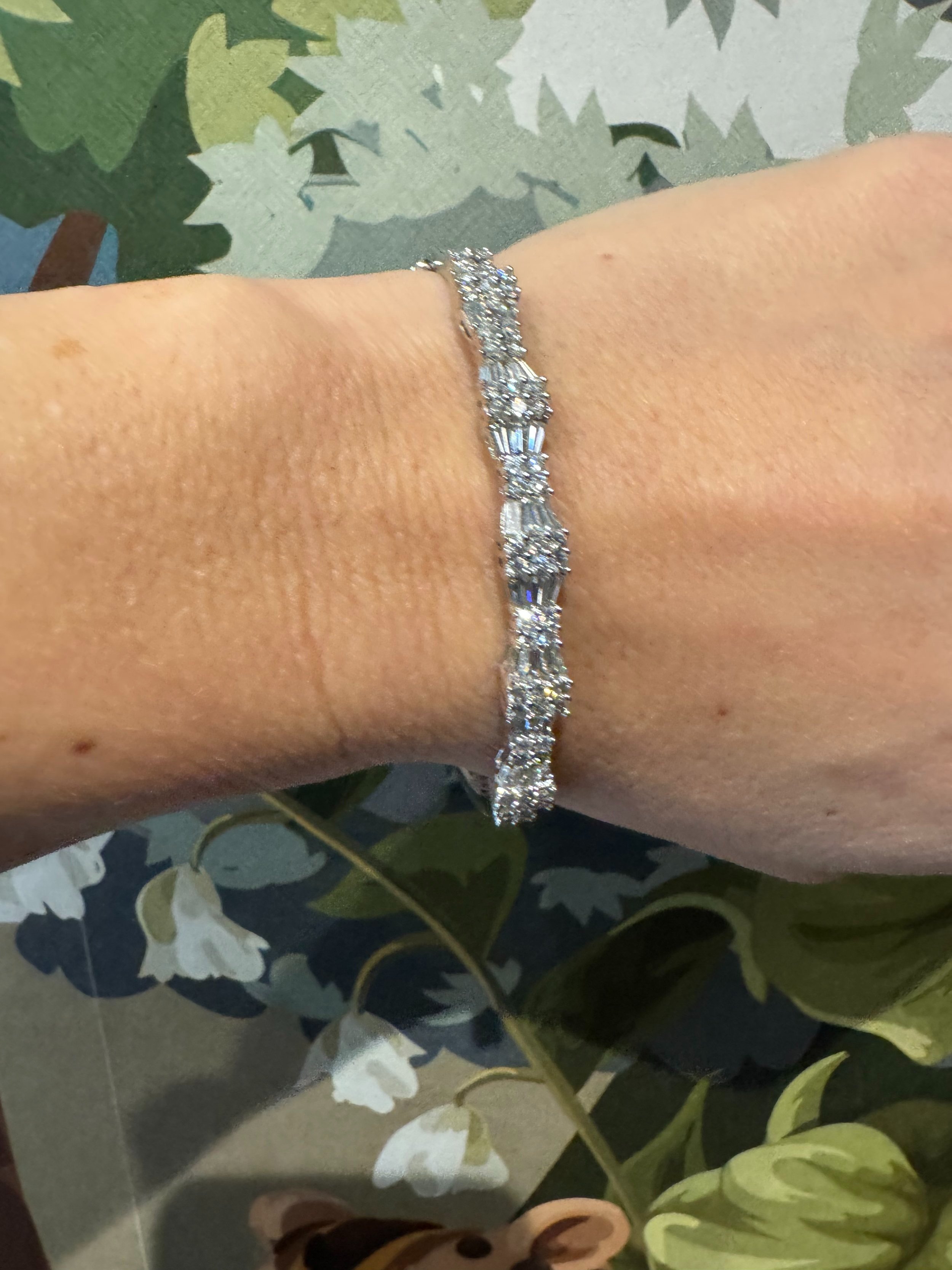 Show stopping contemporary 14ct white gold bangle, set with approximately 2.5cts of brilliant cut and baguette cut diamonds in this fabulous geometric design.