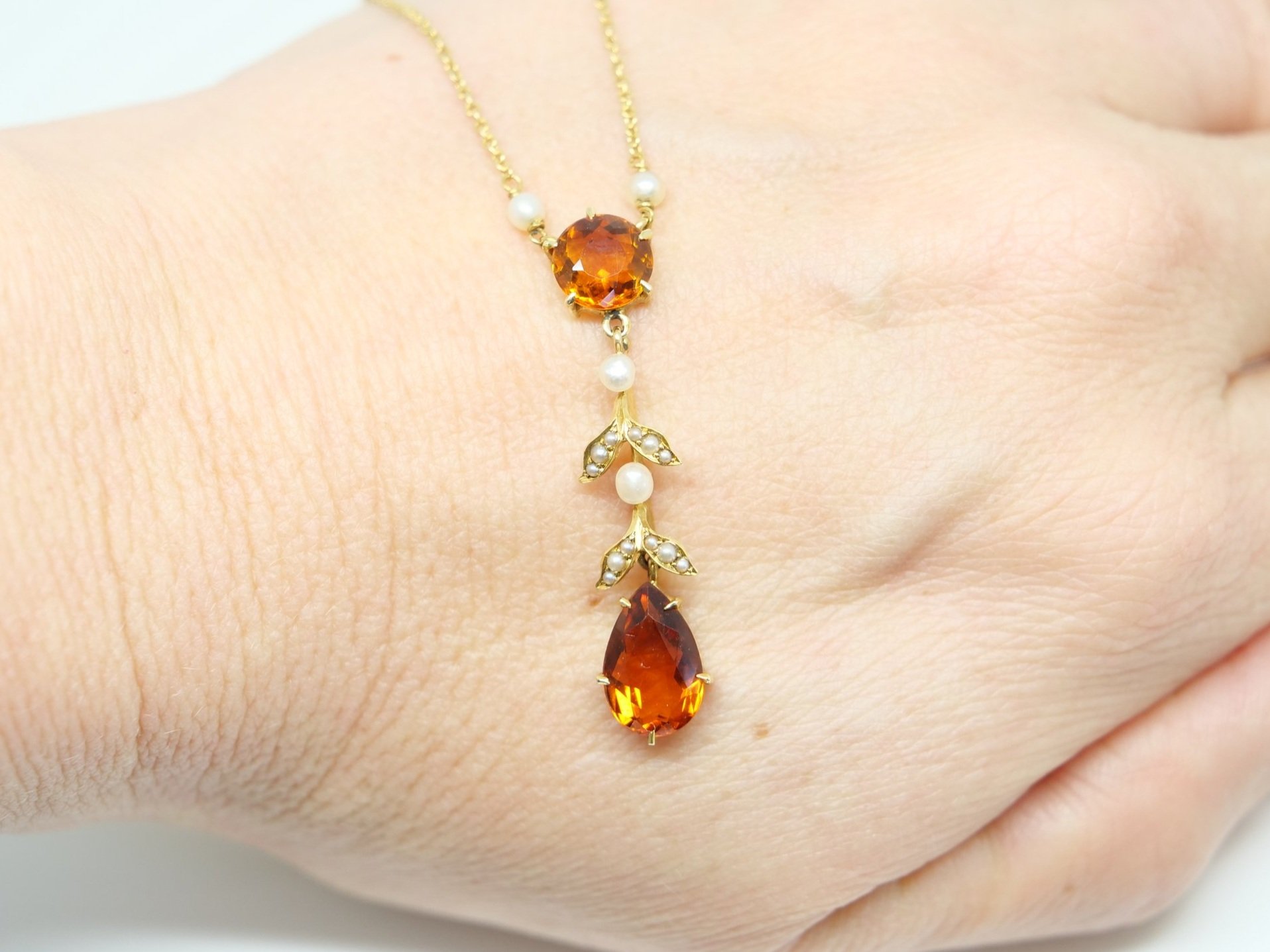Very pretty 14ct gold citrine and seed pearl necklace, set with a round cut and a pear cut citrine, inset with seed pearls in a leaf design.