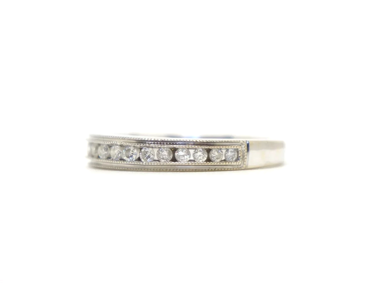 Beautiful 18ct white gold diamond half eternity ring, channel set with a row of brilliant cut diamonds across the front of the band, totalling 0.25ct.