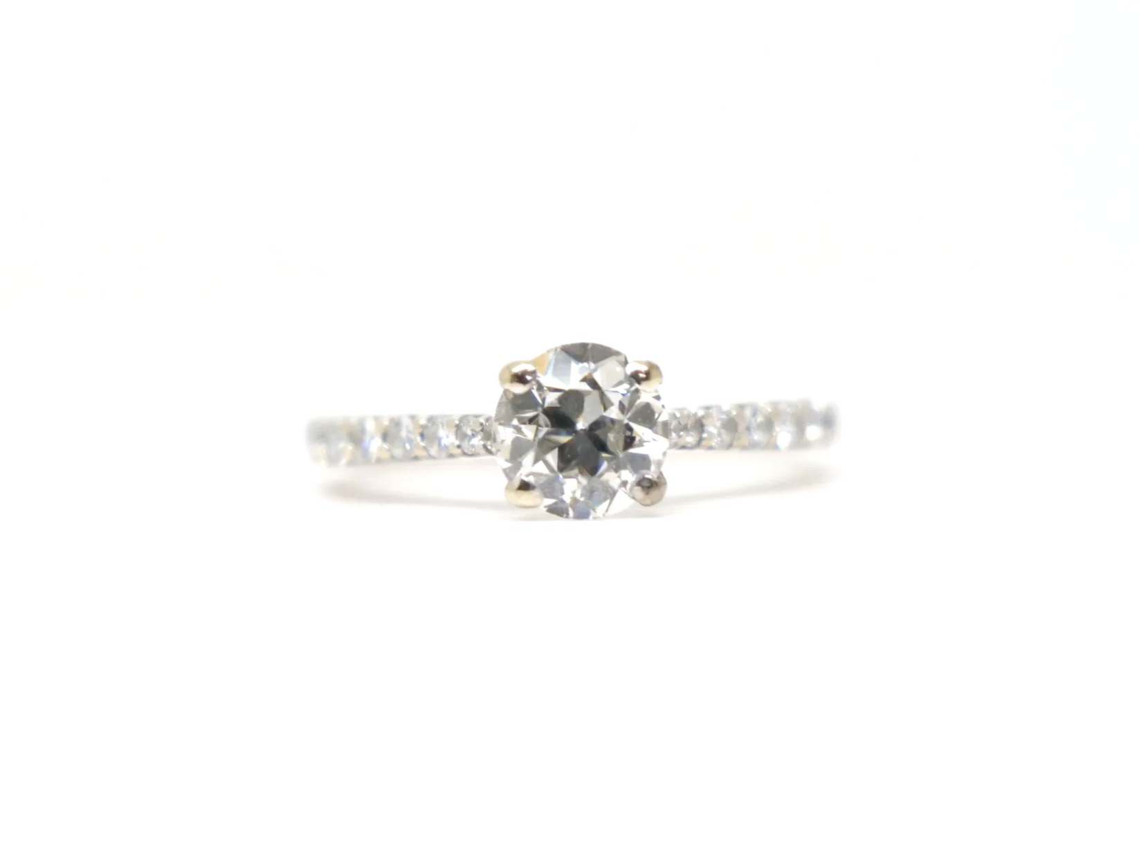 An 18ct gold old cut diamond solitaire with diamond-set shoulders