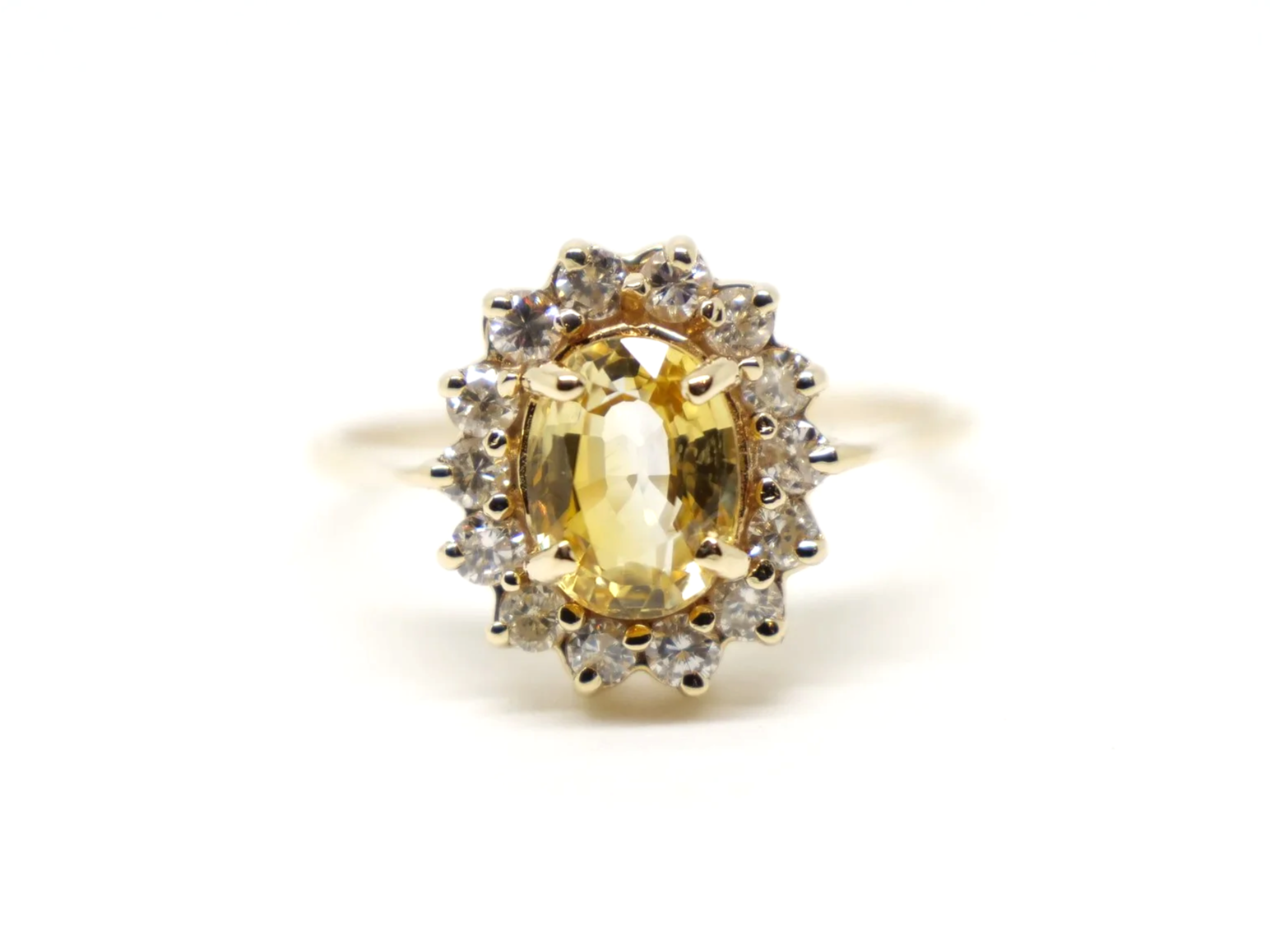 Beautiful 18ct gold yellow sapphire and diamond cluster ring, set with an oval cut yellow sapphire of approximately 2.1ct with a brilliant cut diamond surround.