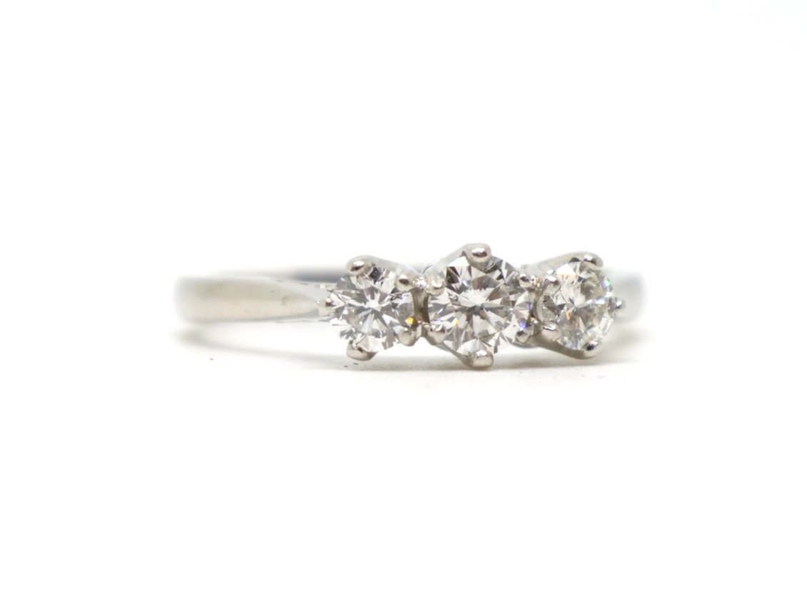 Super platinum diamond three stone ring, set with three brilliant cut diamonds graduating from centre stone. Approximately 0.86ct total diamonds.