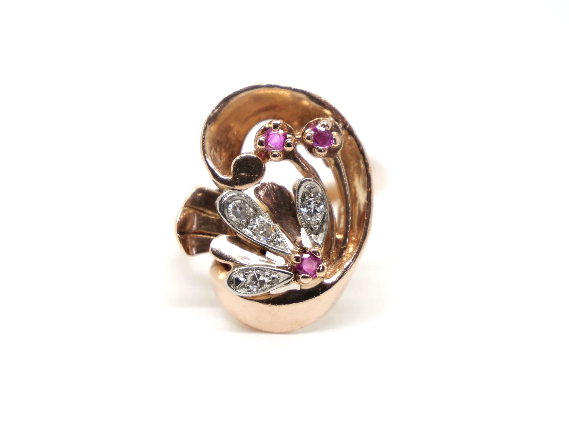 Very unusual 14ct rose gold Art Deco ring, in a large swirl style design. Each of the flower elements of the ring are set with round cut rubies, with diamonds set into each petal.