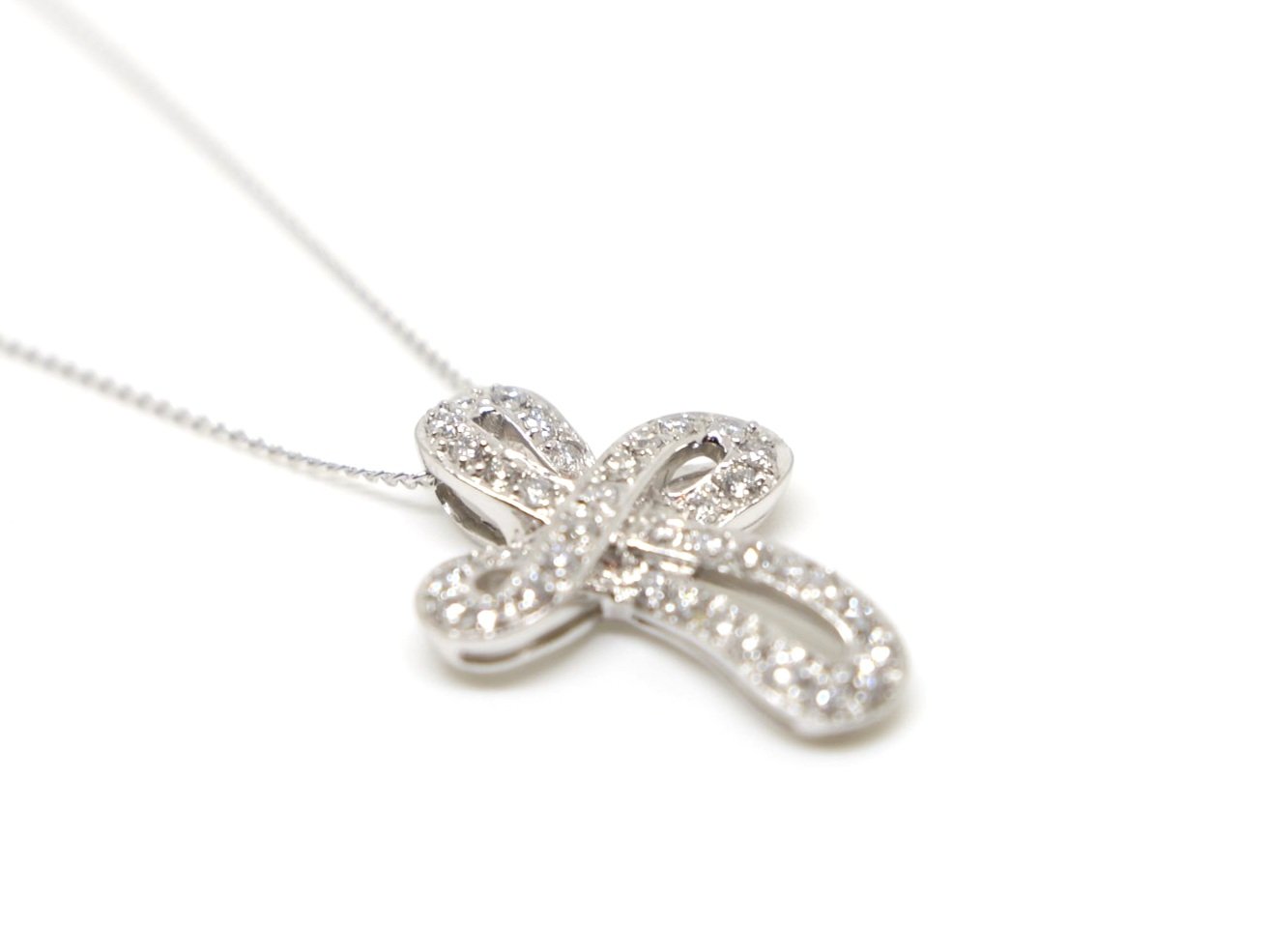 Stunning platinum diamond cross pendant, set with beautiful brilliant cut diamonds in this contemporary cross style design. With 16” 18ct white gold chain.