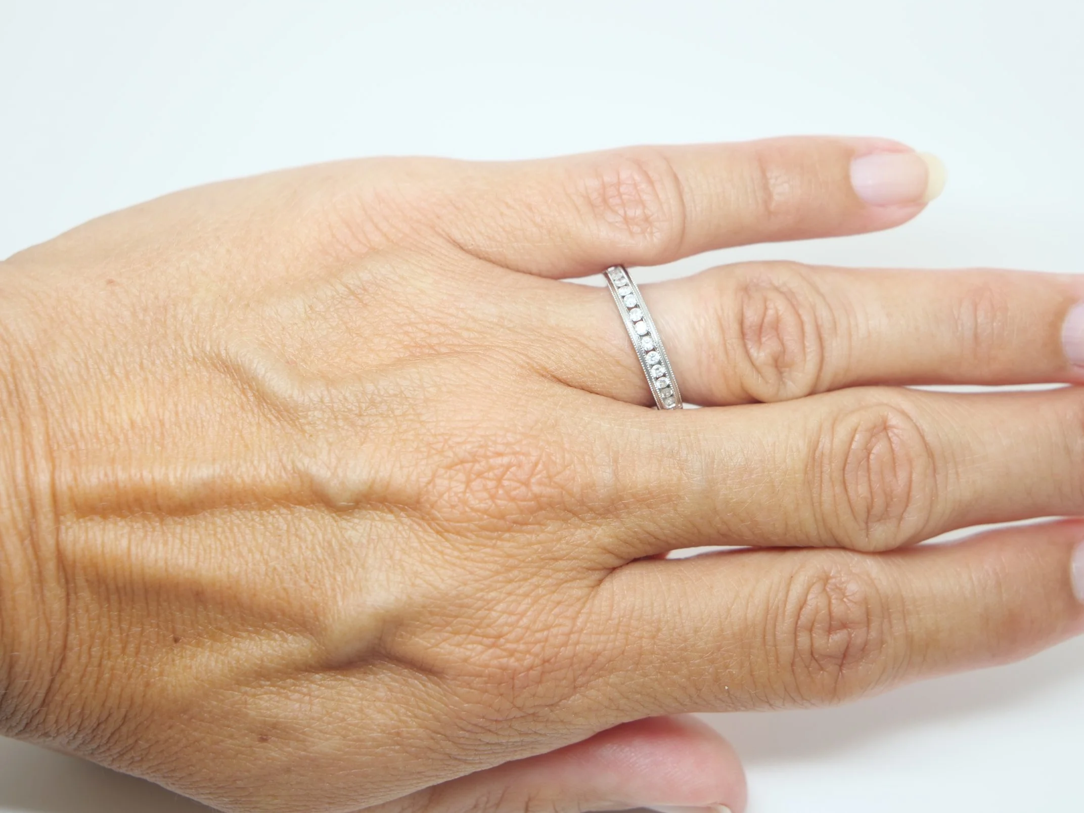 Beautiful 18ct white gold diamond half eternity ring, channel set with a row of brilliant cut diamonds across the front of the band, totalling 0.25ct.