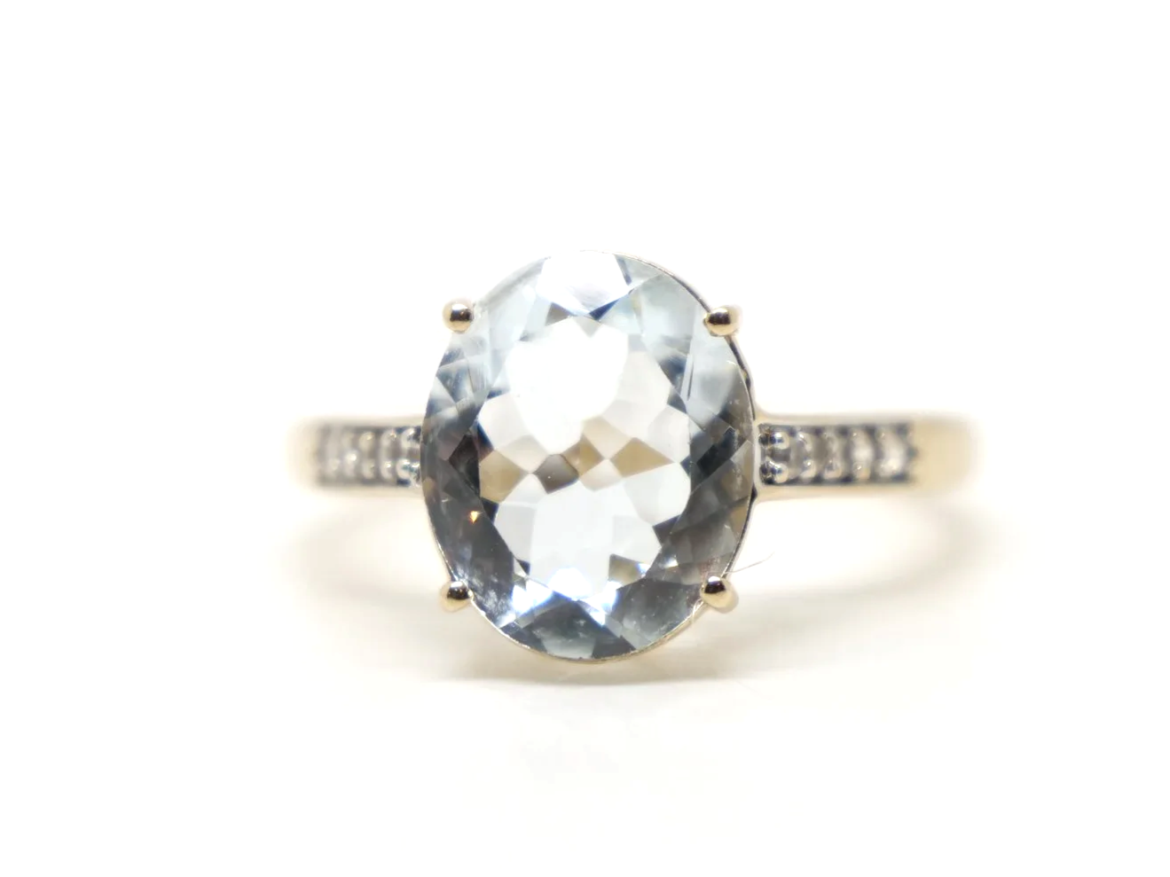 Lovely 10ct gold aquamarine and diamond cocktail ring, set with a large oval cut aquamarine with small diamonds to each shoulder.