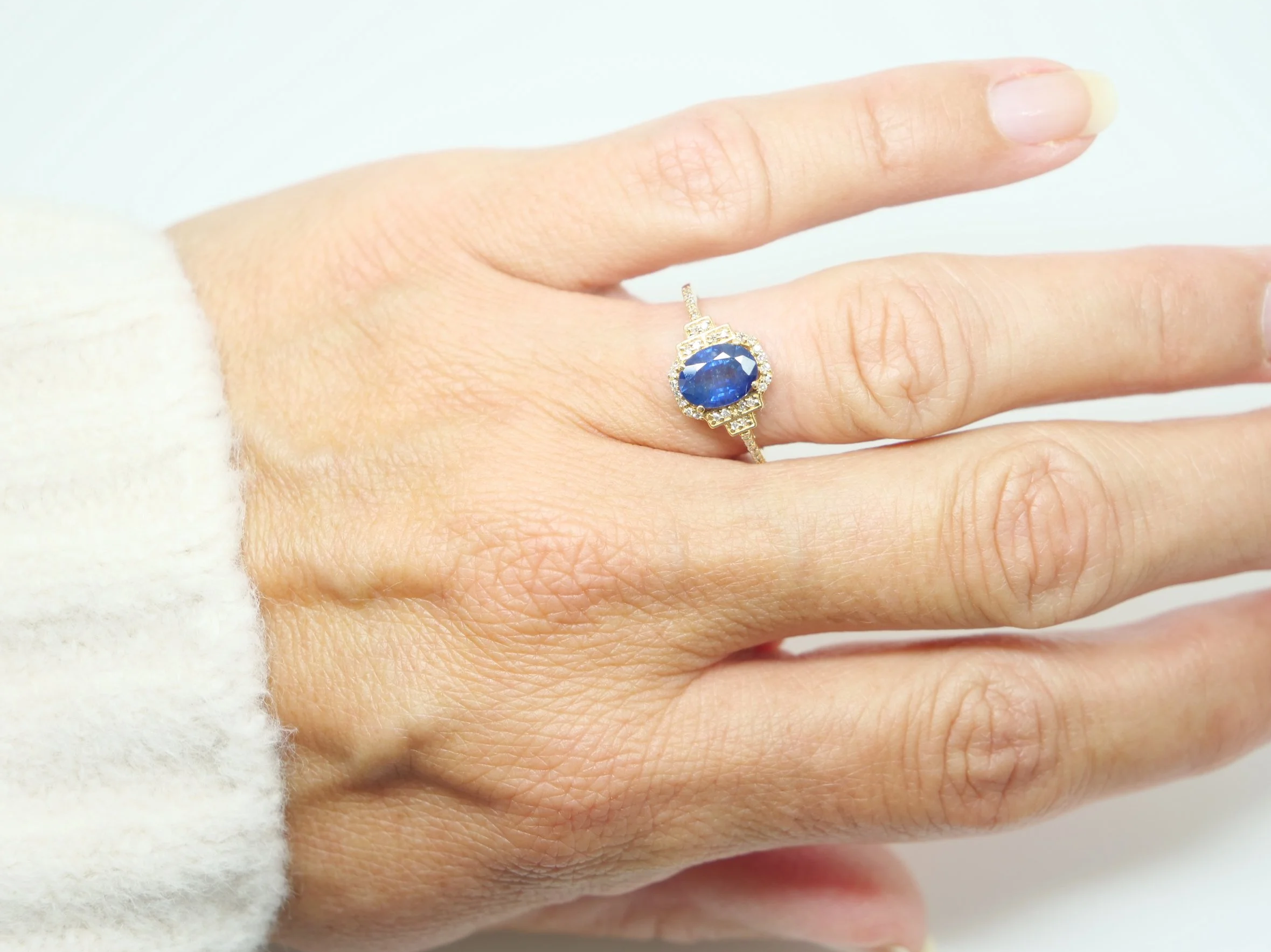 14ct gold sapphire and diamond halo ring, oval blue sapphire with Art Deco style diamond shoulders, UK size N½