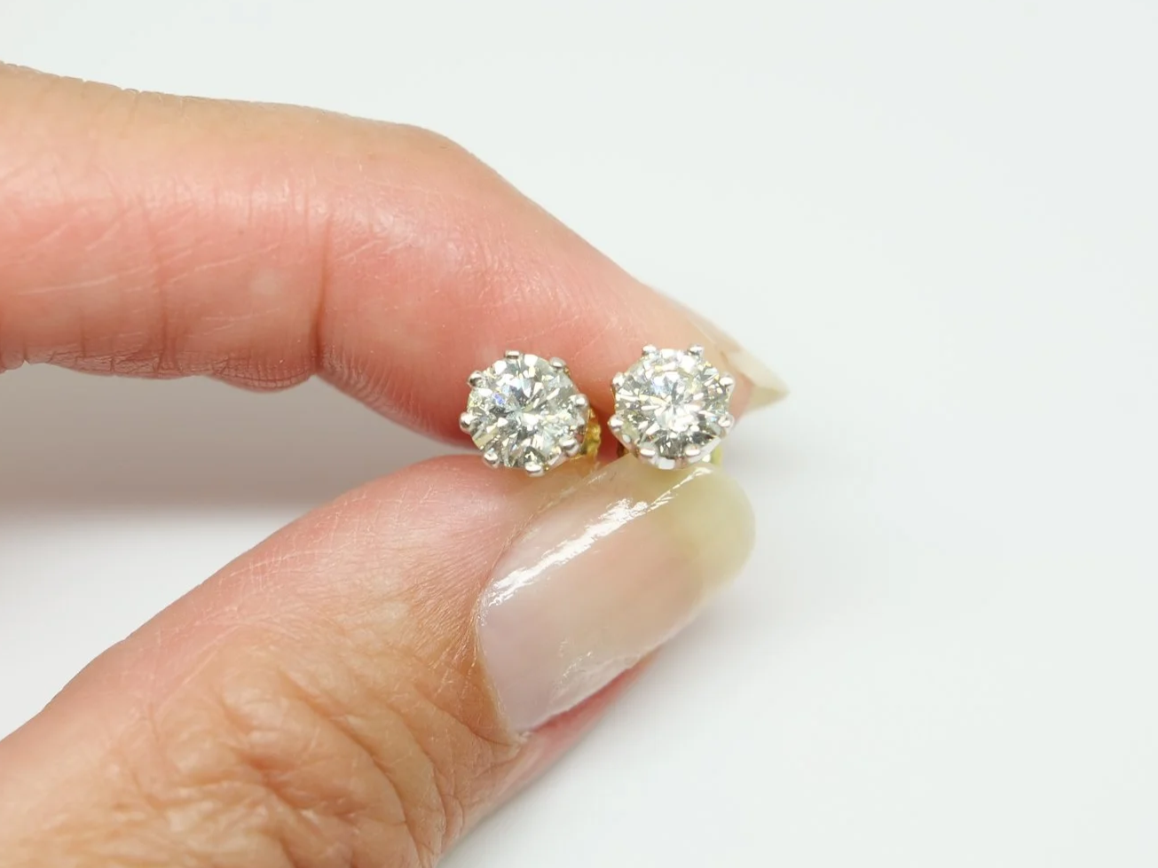 Lovely pair of 18ct white gold diamond stud earrings, each set with a round brilliant cut diamond of approximately 0.85 carats.