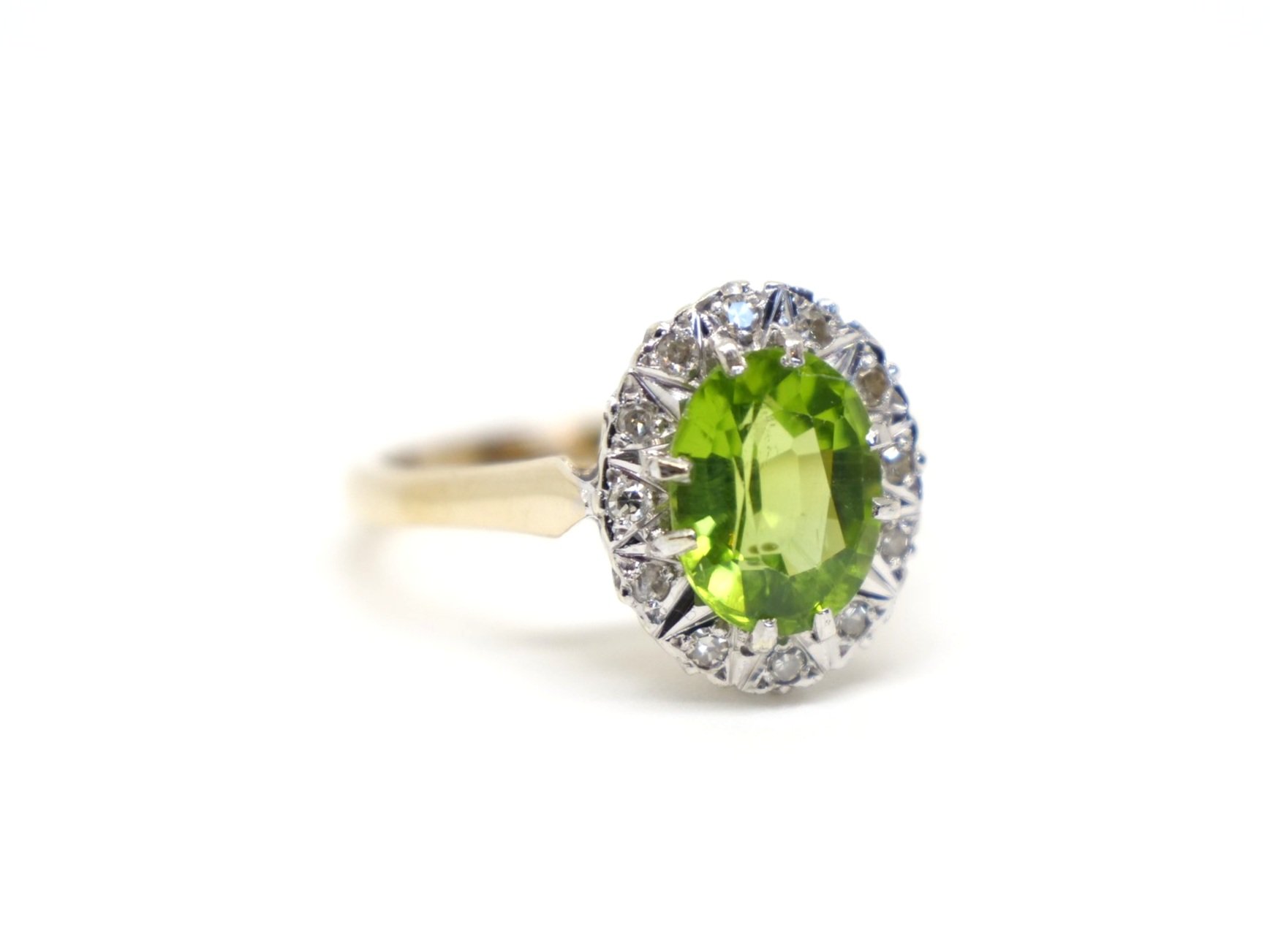 Lovely vintage 9ct gold peridot and diamond cocktail ring, set with a large central oval cut peridot and surrounded by small inset diamonds.