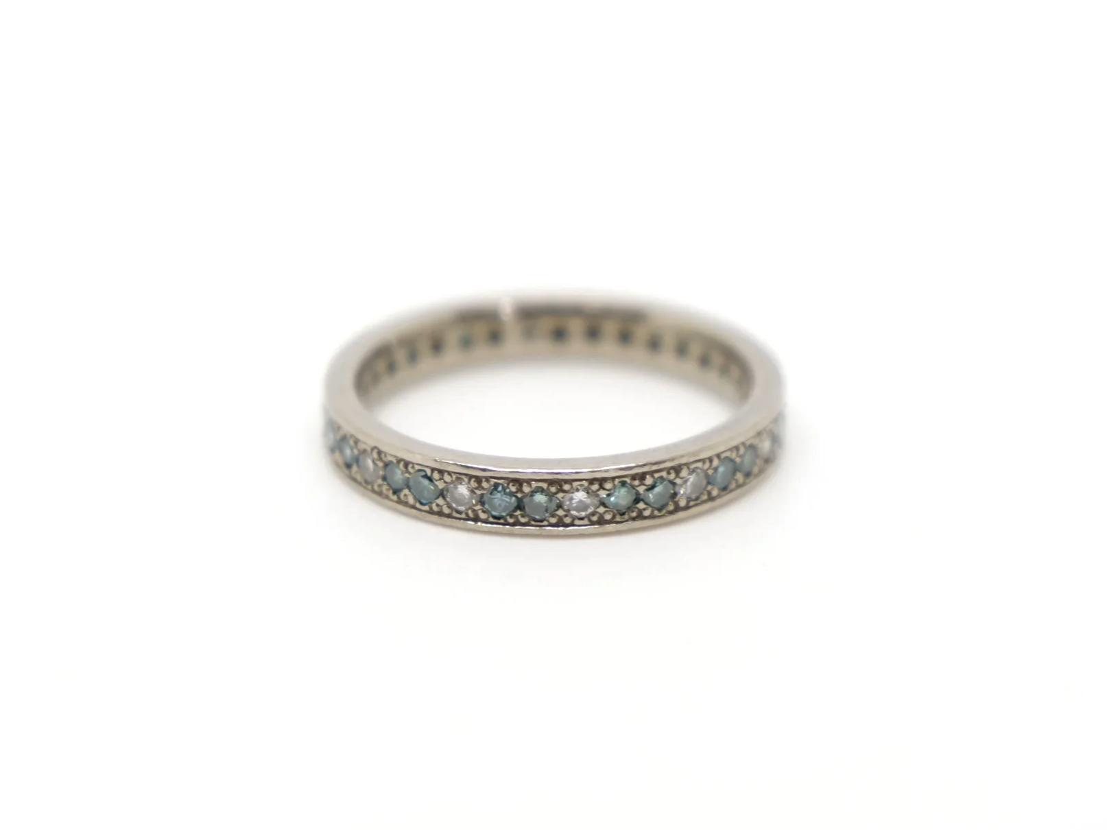 An 18ct white gold eternity ring alternating brilliant-cut white and blue diamonds, 0.59ct total. UK size I½. A rare vintage find, ready to ship.