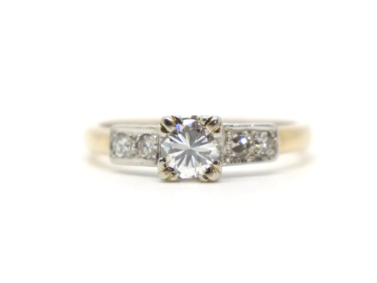 Stunning vintage 18ct gold diamond solitaire ring, set with a central brilliant cut diamond and with further small diamonds to each shoulder.