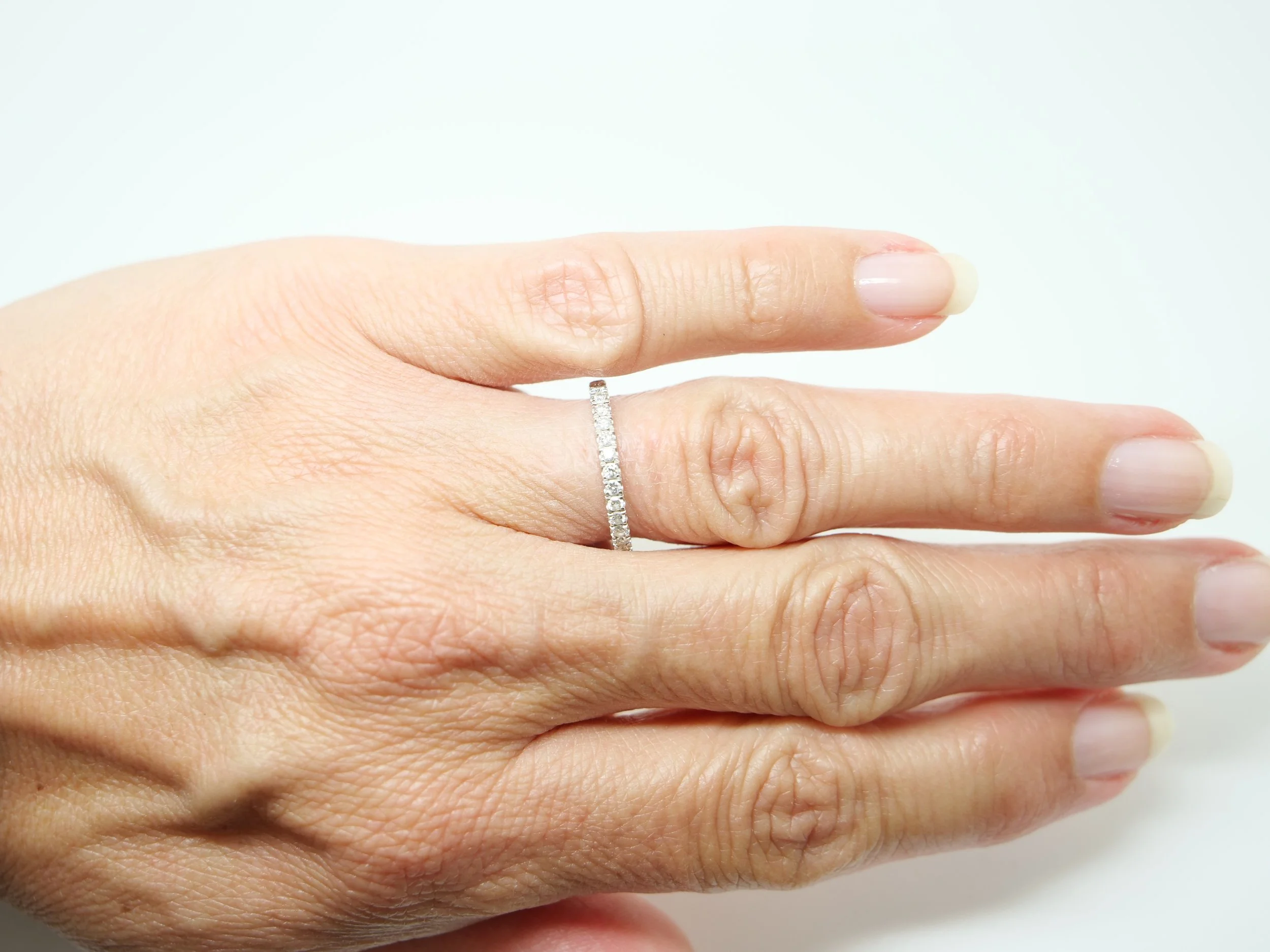 platinum diamond two thirds eternity ring set with round brilliant-cut diamonds pavé-set around the band