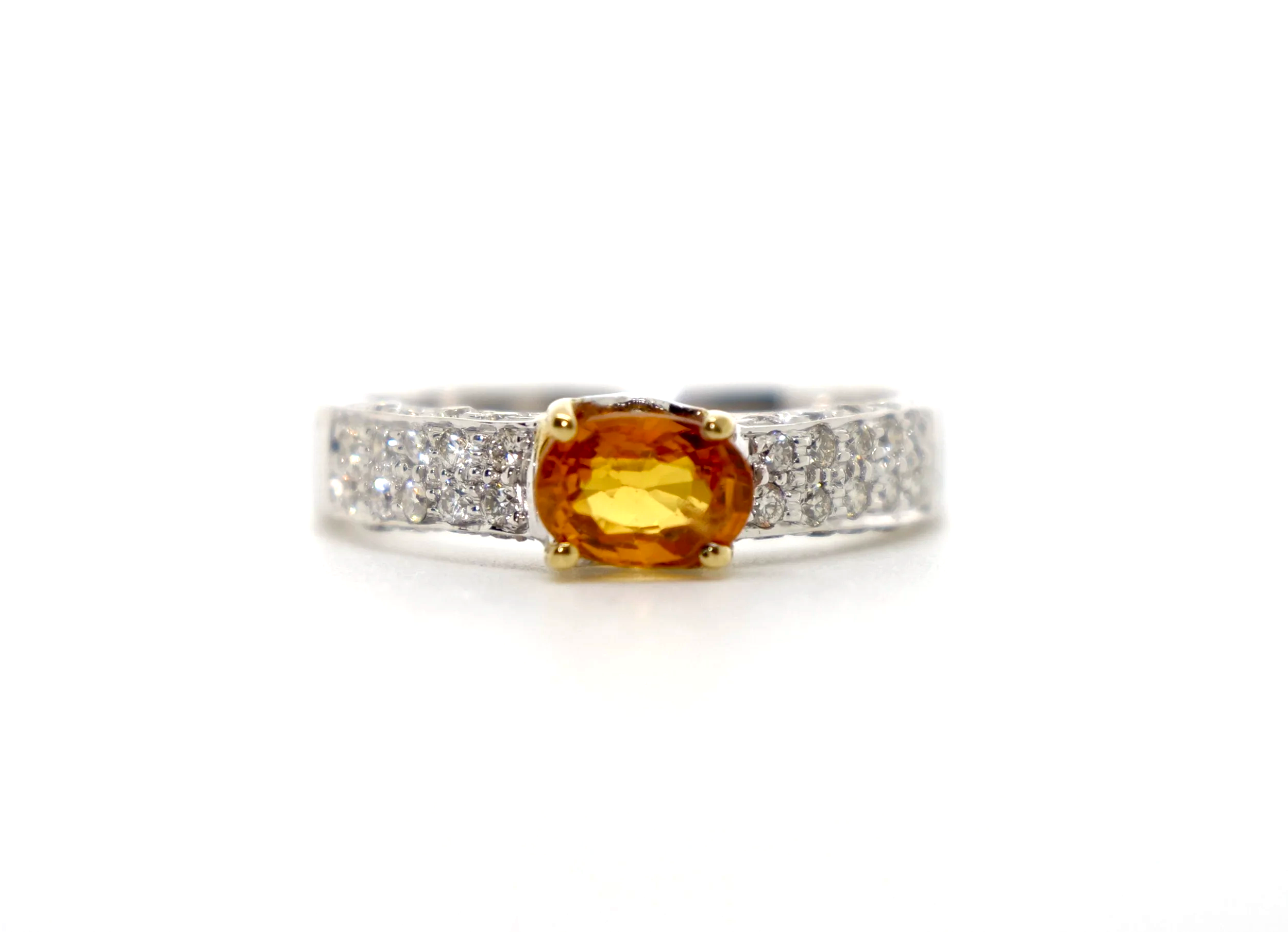 Beautiful 18ct gold orange sapphire and diamond ring, with a vibrant orange sapphire in an east-west setting, with pave style diamonds to each shoulder.