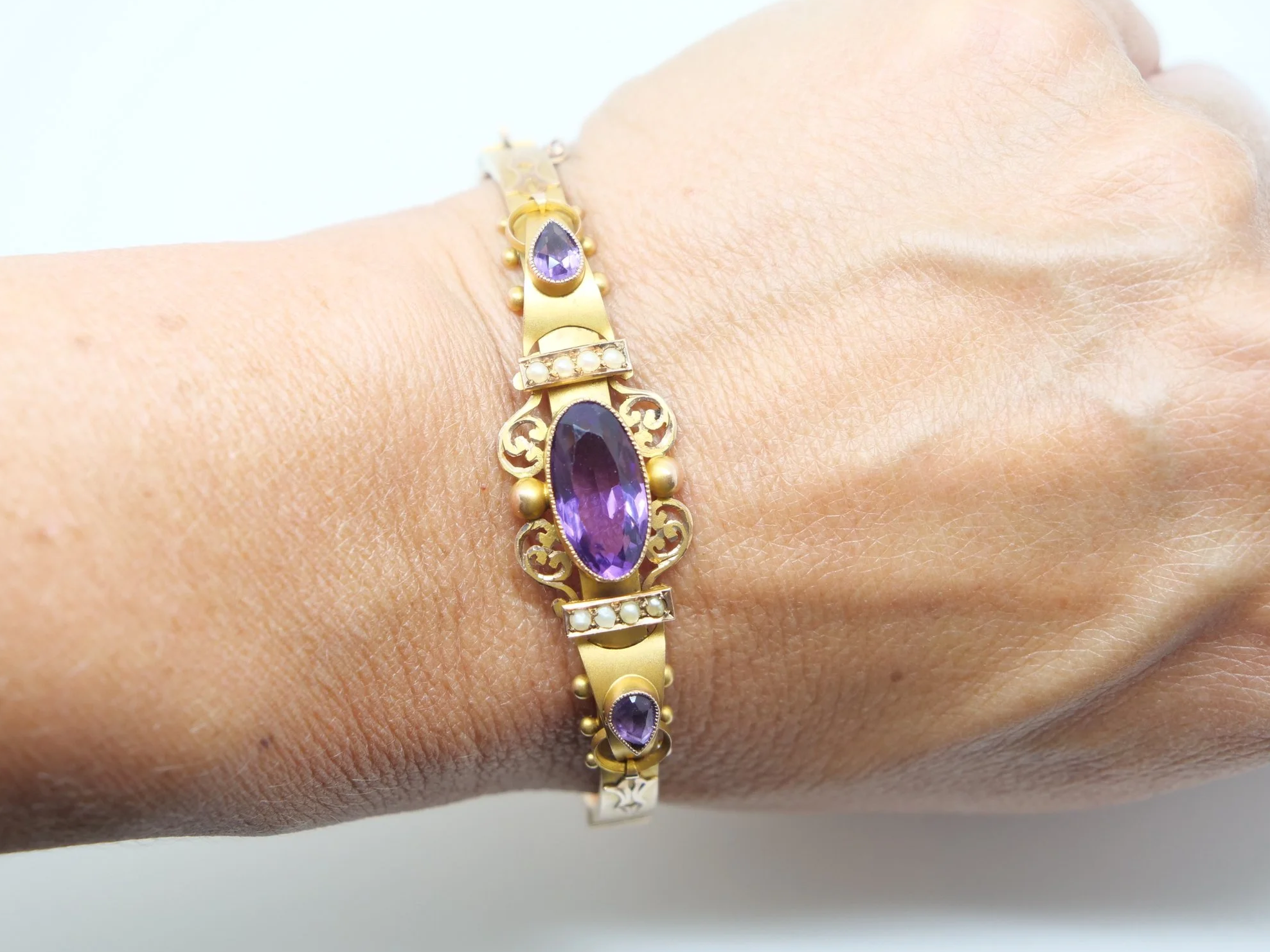 Beautiful Victorian style 9ct gold amethyst and seed pearl bangle, set with a lovely oval cut central amethyst with a pear cut amethyst to each side.