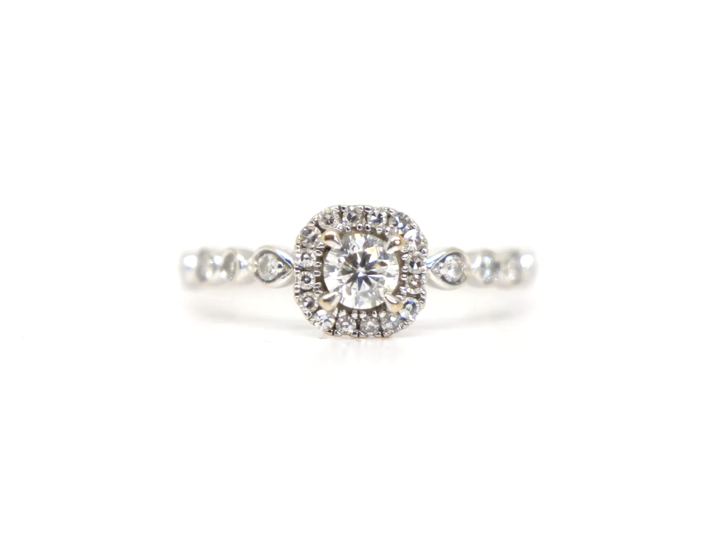 A platinum diamond halo ring by Emmy London, set with a round brilliant cut diamond at the centre surrounded by a cushion-shaped halo of smaller diamonds