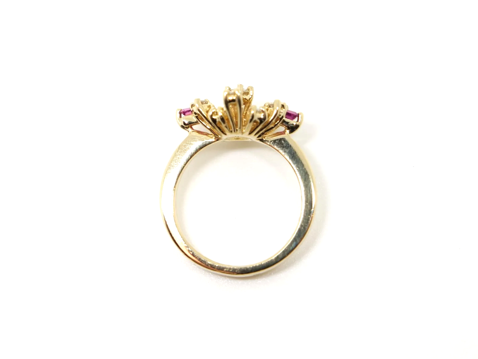 Unusual vintage 14ct gold ruby and diamond spray design ring, with a diamond centre and further diamonds in this east west marquise design. Highlighted with two tapered baguette cut rubies.