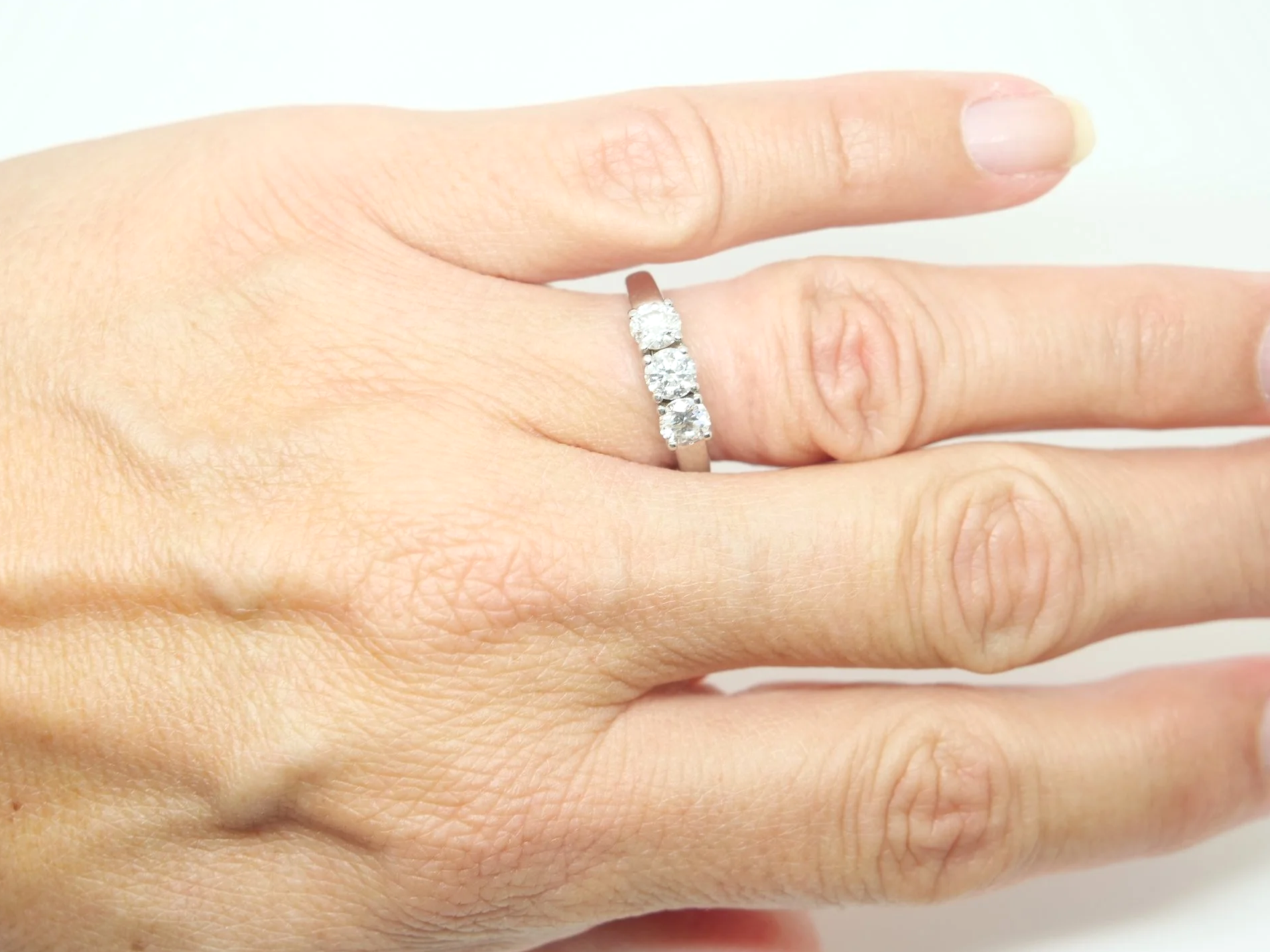 Platinum diamond three stone ring, round brilliant cut diamonds
