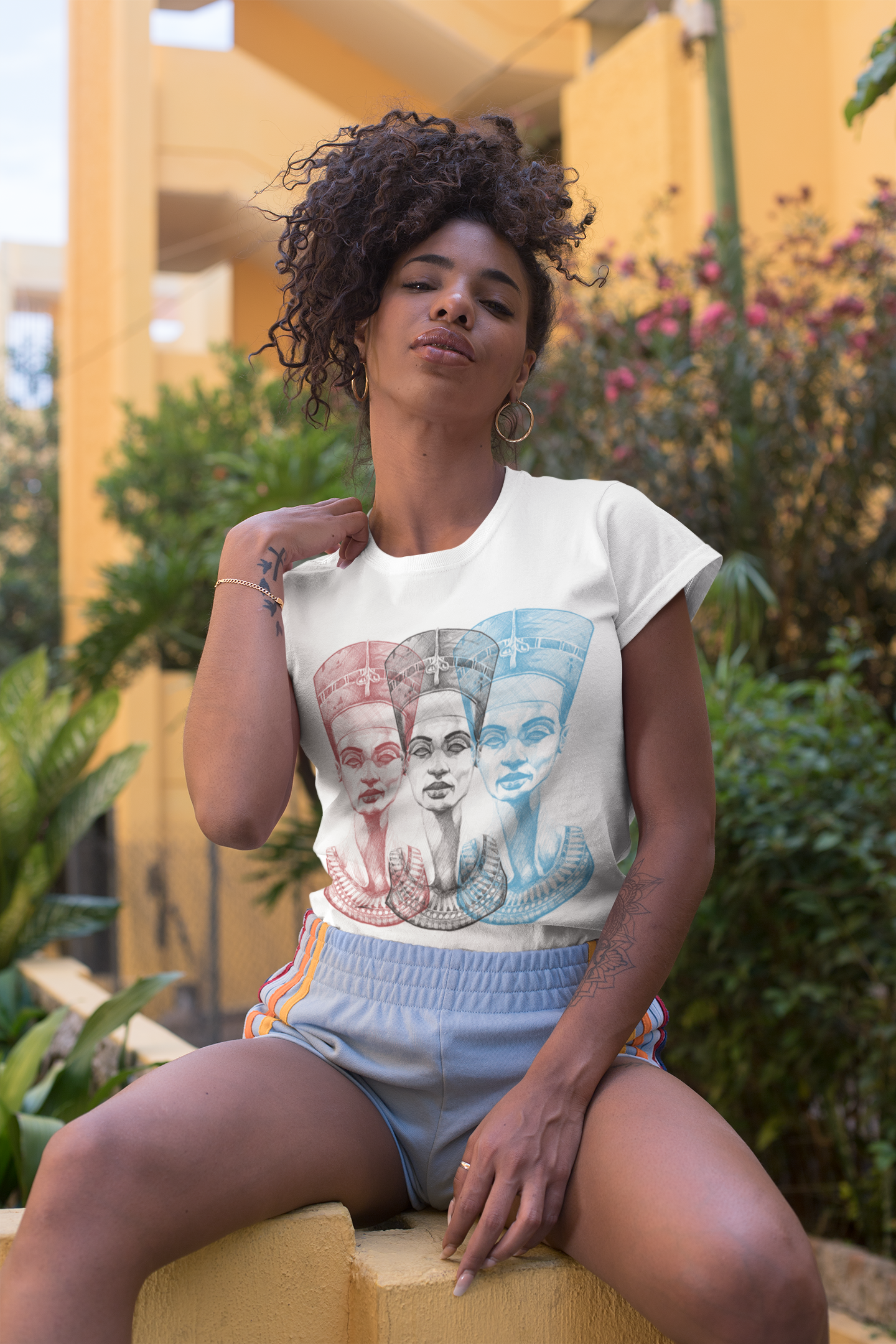t-shirt-mockup-of-a-fierce-woman-sitting-by-a-yellow-building-27351.png
