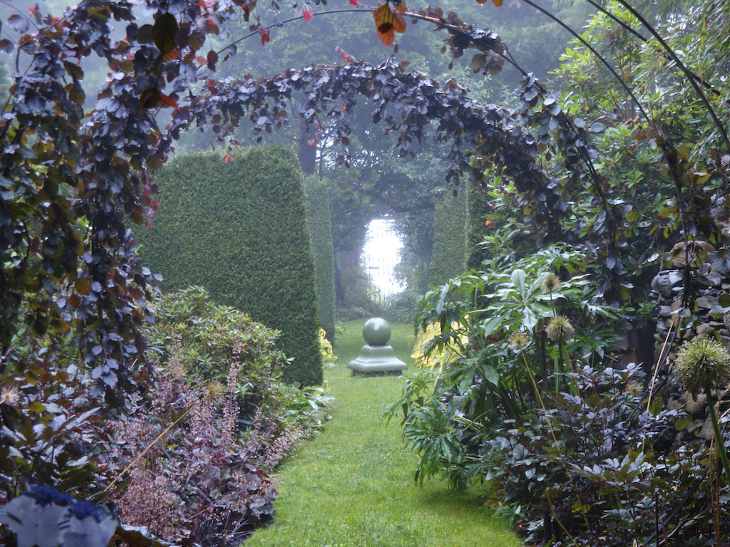 The Black Border MF: Dark is chic. Let's face it, there are no black plants, but gardeners love to romanticize. What makes this path exciting for me are the circles that draw you along in either direction. Both ways lead into the light. JAG: A century ago Gertrude Jekyll lobbied for juxtaposing plants on the opposite sides of the color wheel in order to give each color greater intensity. The black border theoretically should look darker after your eye is blasted by the adjacent yellow garden. MF: Gertrude was right. It works.