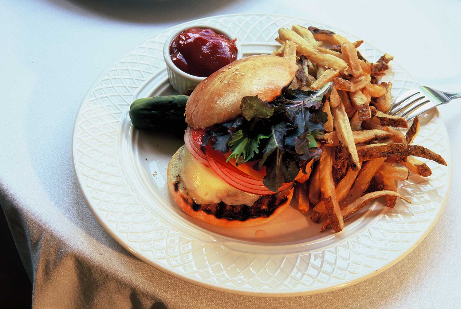 Grass-fed Pigasso Farms burger with hand cut fries on a challah bun