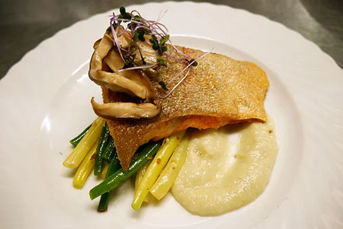 Pan-roasted Salmon Fillet with white bean and roasted garlic puree, green beans, and pickled local chanterelle mushrooms