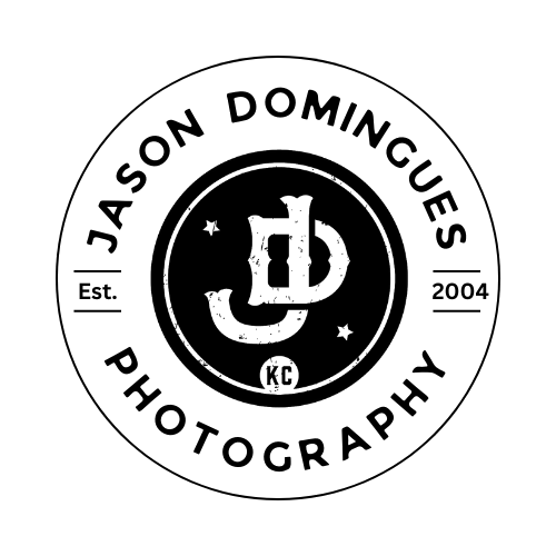 A circular logo with the text "Jason Domingues Photography," "Est. 2004," and "KC." The center features a stylized monogram with the initials 'JD' surrounded by stars.