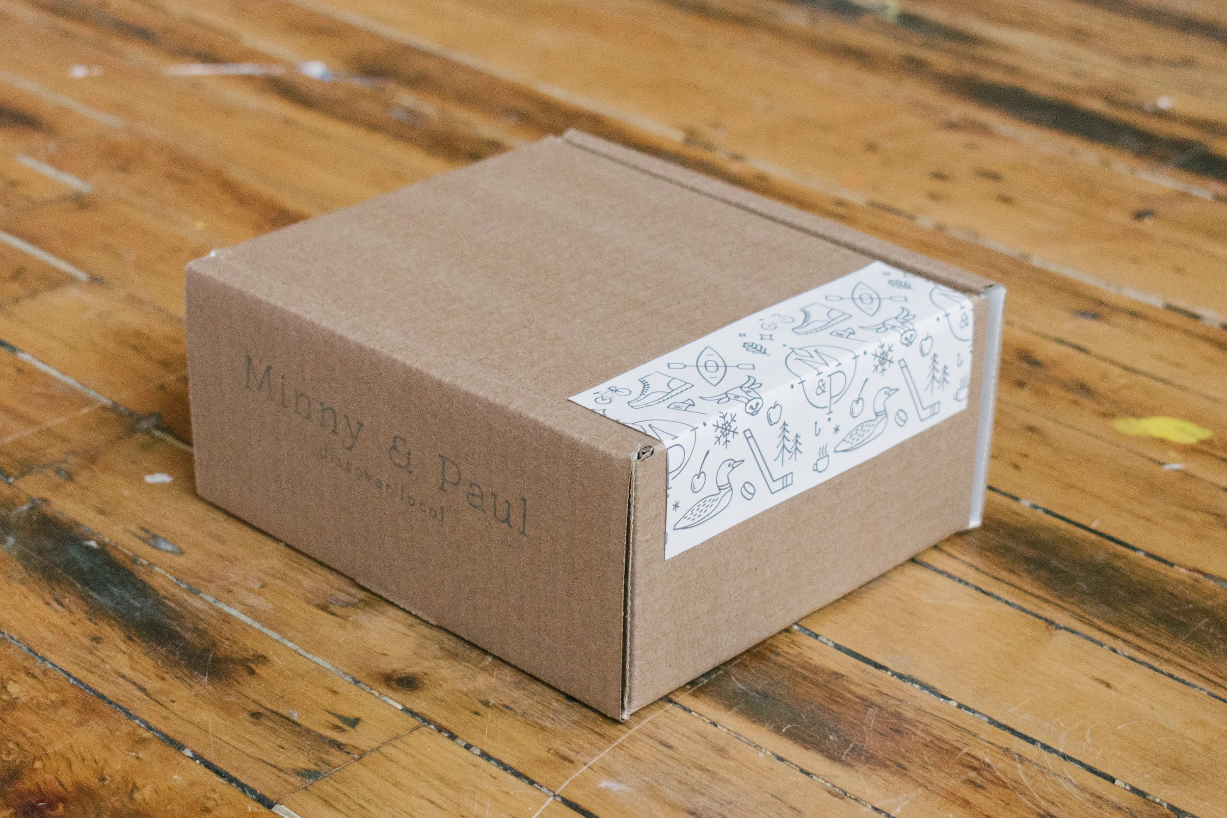 The newly designed and illustrated packaging tape for M&P, featuring Minnesota iconography.