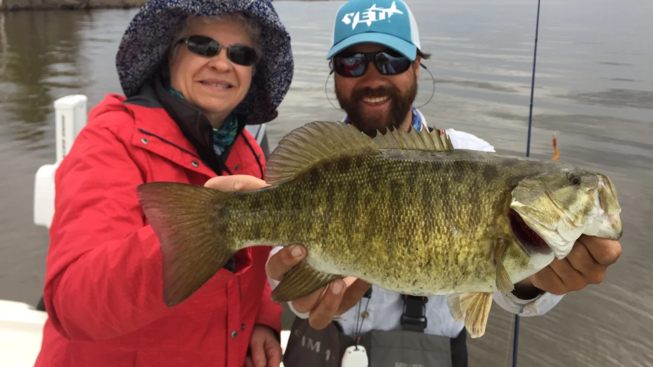 Kathy worked a "Roger Rig" out the back of the boat while her husband Gary threw topwater flies out the front. Both picked up fish including this one. Yes, that little hook on the 1/32 oz jighead can work on a big fish like this. 