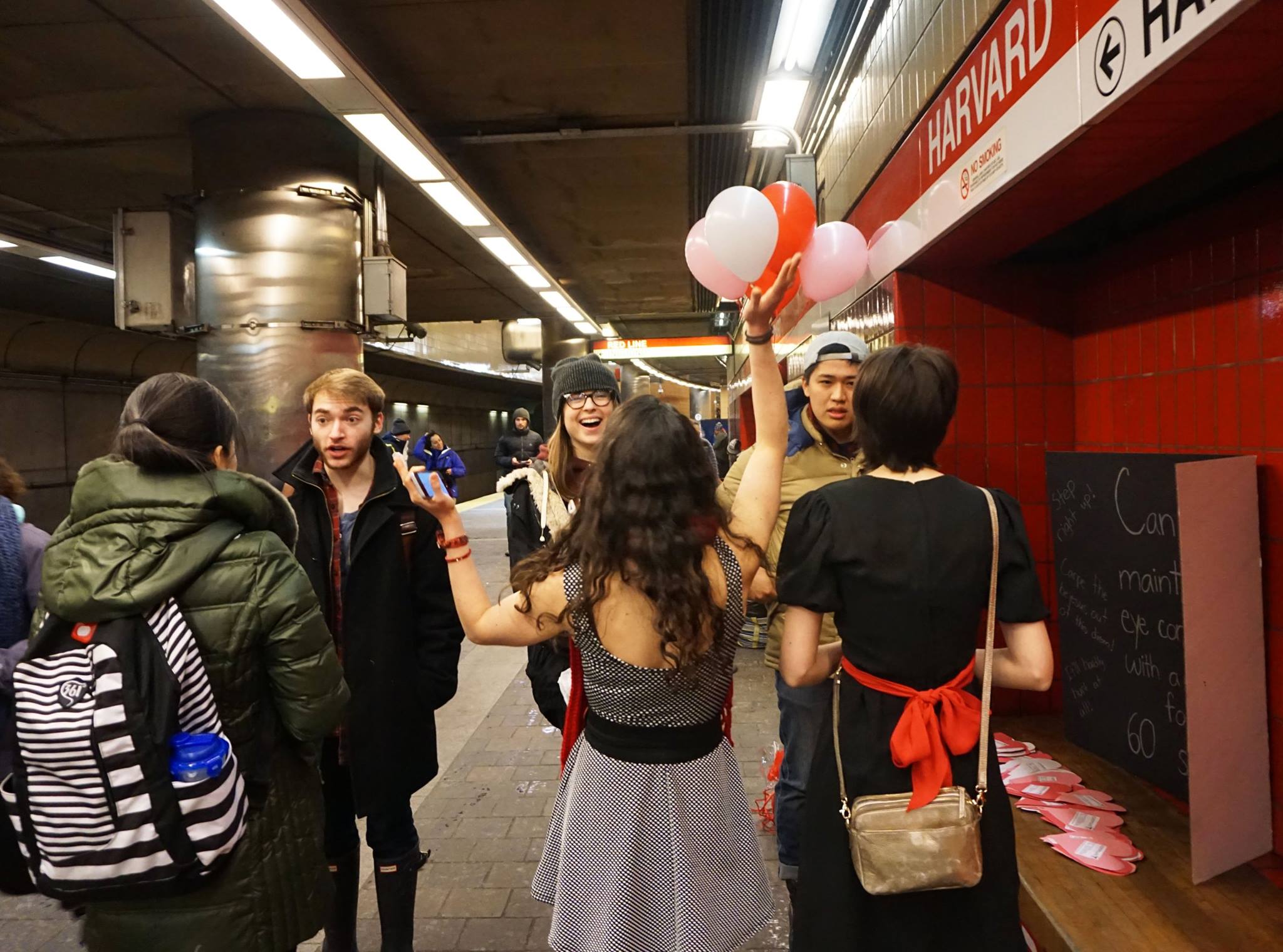  Woman holding balloons in subway station  