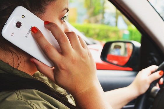 Talking on a cell phone and driving is not illegal. Distracted driving is illegal.