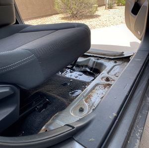 flood damaged car with waterlogged interior and corroded wiring