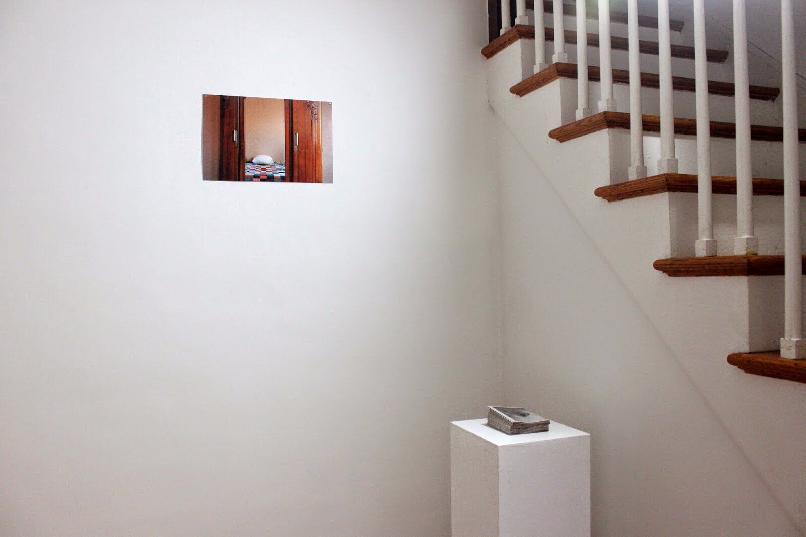  installation view with photographs from&nbsp;  Chambres   &nbsp; (2005) and the publication,&nbsp; Taysir Batniji: Full Bleed  