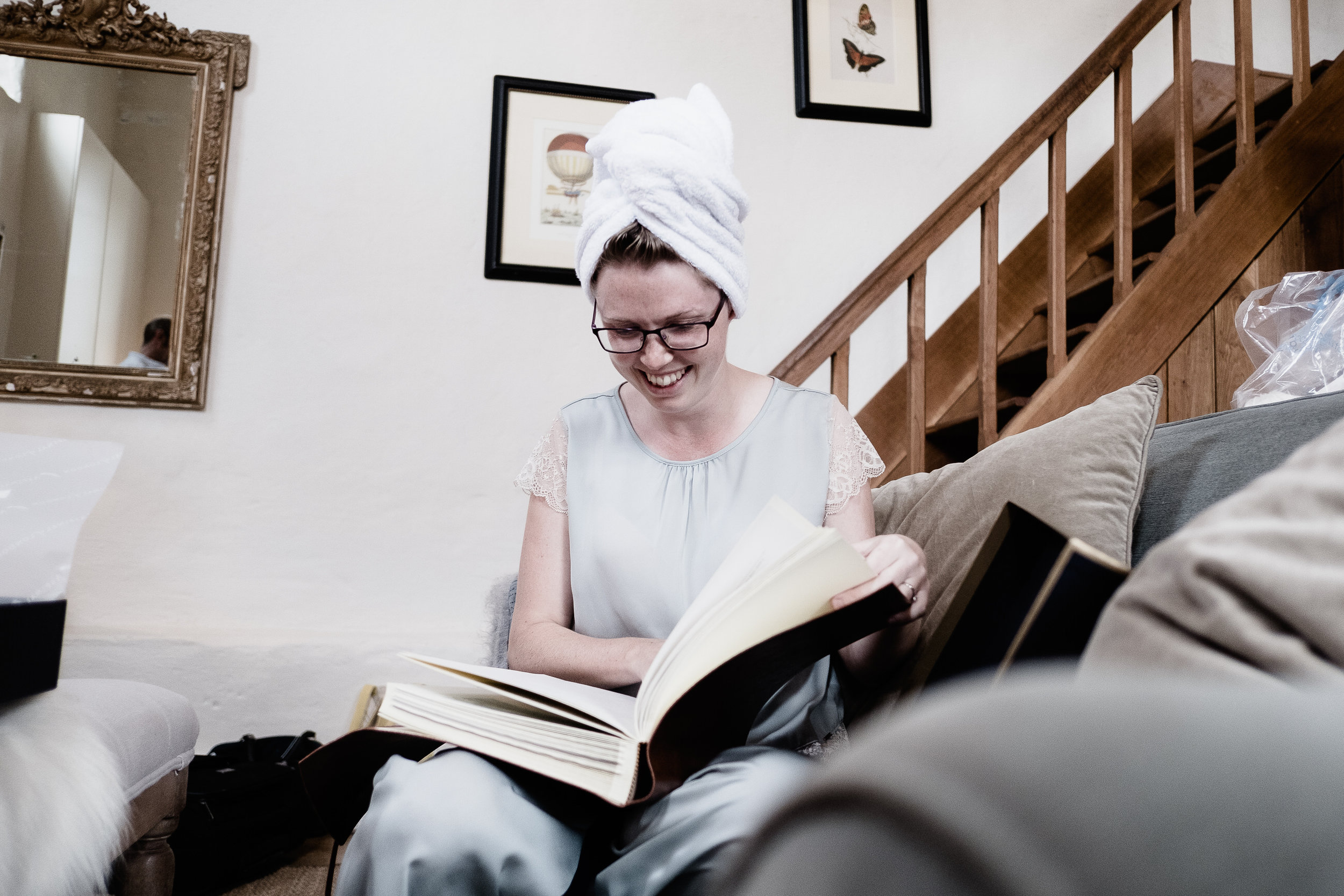 A bride looking at a book  at Merriscourt Wedding Venue, Oxfordshire