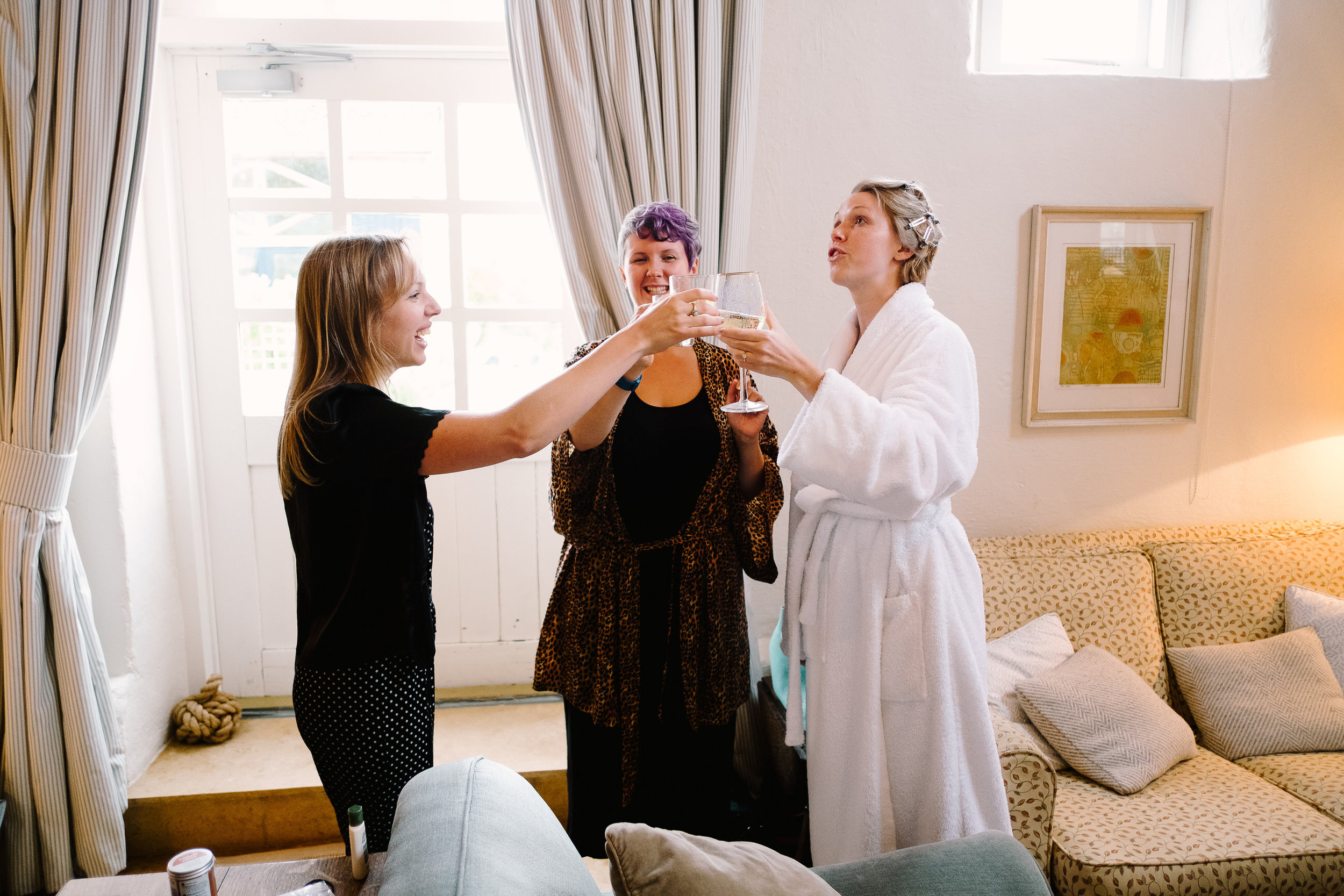 A bride and bridemaids drinking champagne at Merriscourt Wedding Venue, Oxfordshire