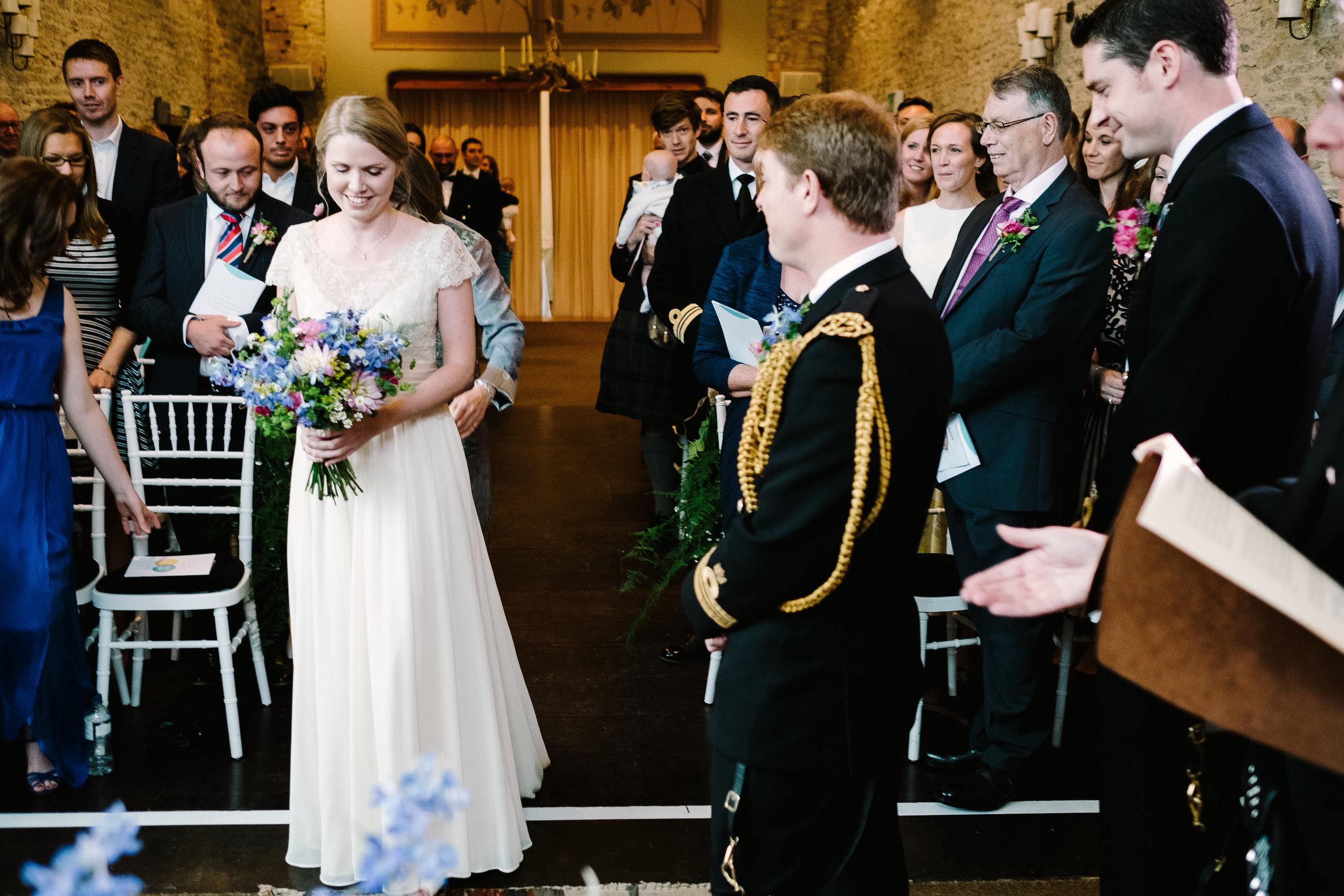 A bride approaches her groom at Merriscourt Wedding Venue, Oxfordshire