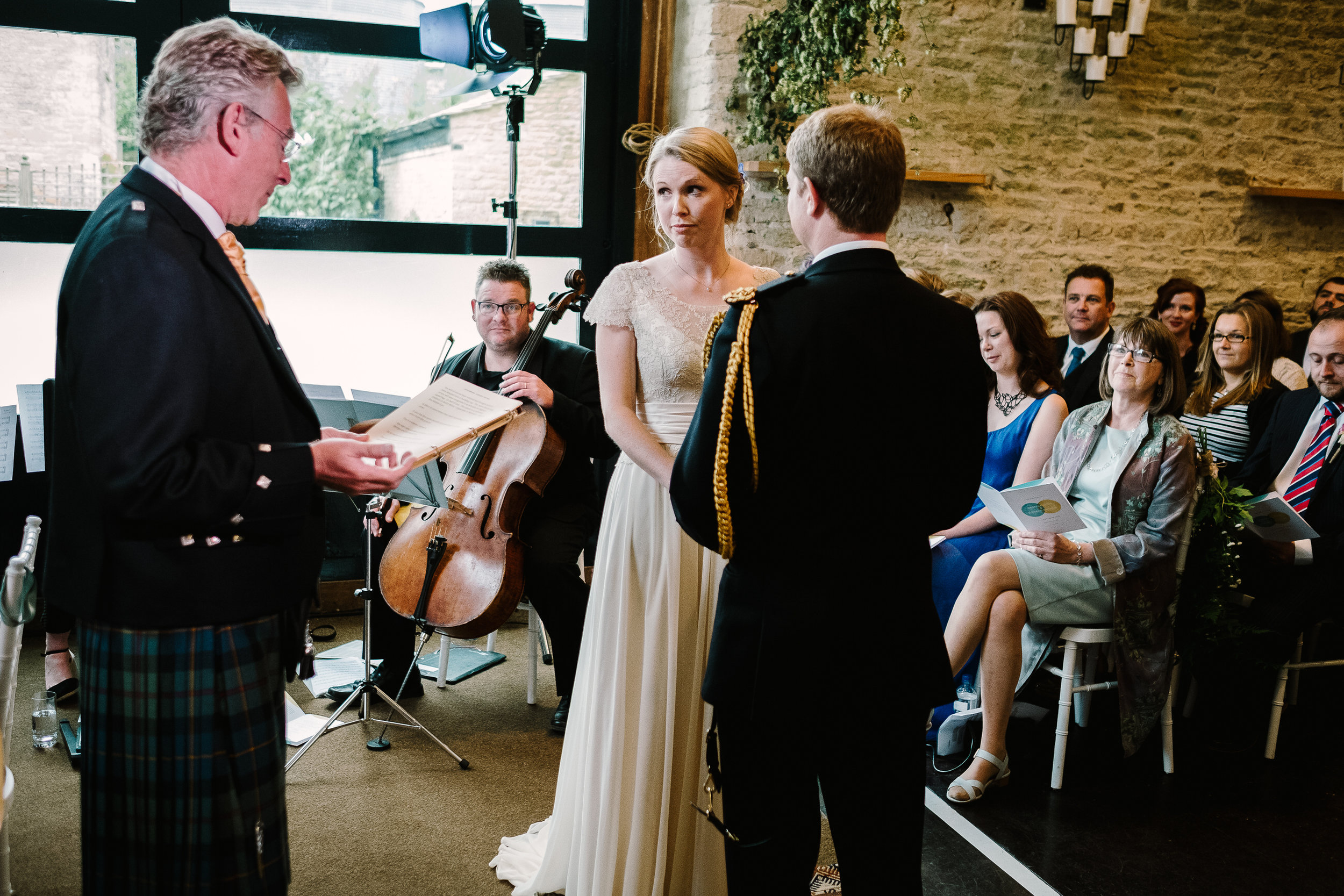 A celebrant leads the ceremony at a wedding at Merriscourt Wedding Venue, Oxfordshire