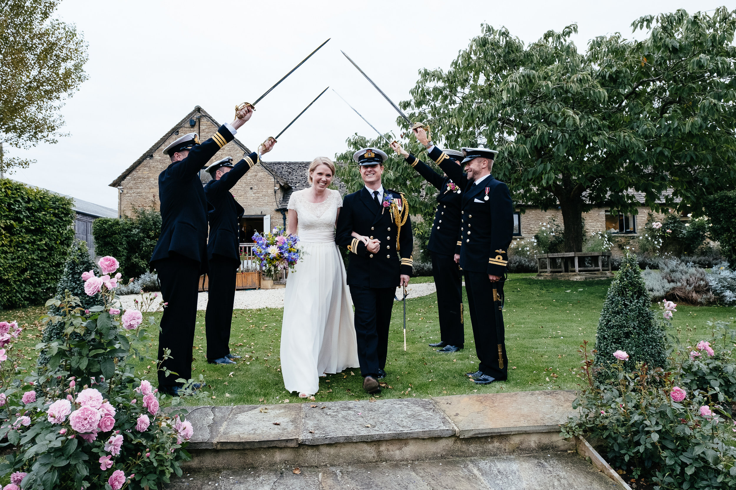 A guard of honor for the bride and groom at Merriscourt Wedding Venue, Oxfordshire