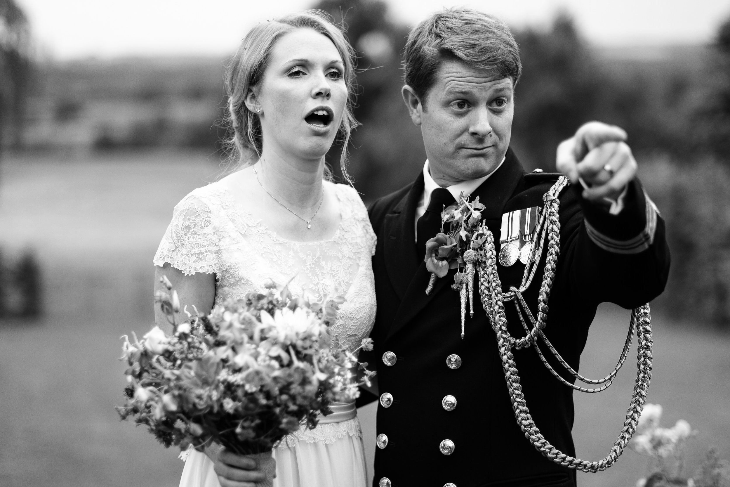 A groom pointing at a wedding at Merriscourt Wedding Venue, Oxfordshire