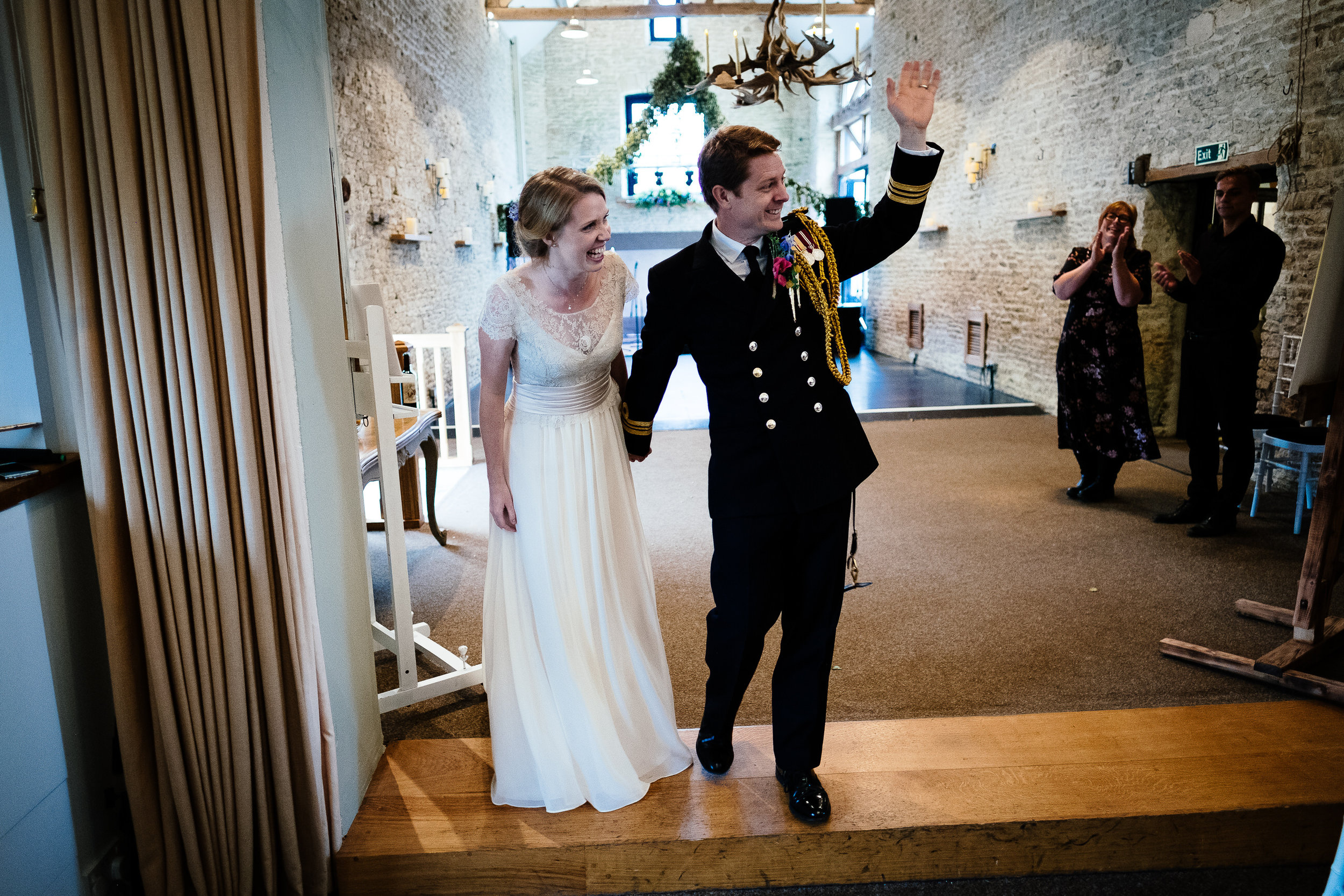 A bride and groom entering the room at a wedding at Merriscourt Wedding Venue, Oxfordshire