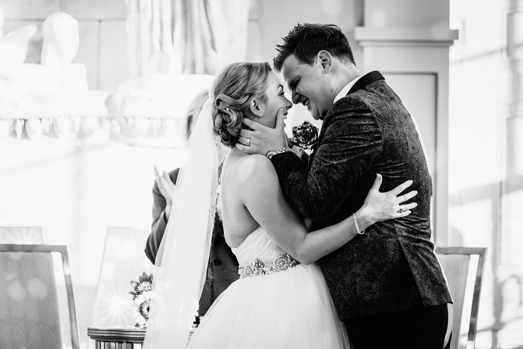 A bride and groom kiss during their wedding at Aynhoe Park, Northamptonshire. Photo by Sam and Steve Photography