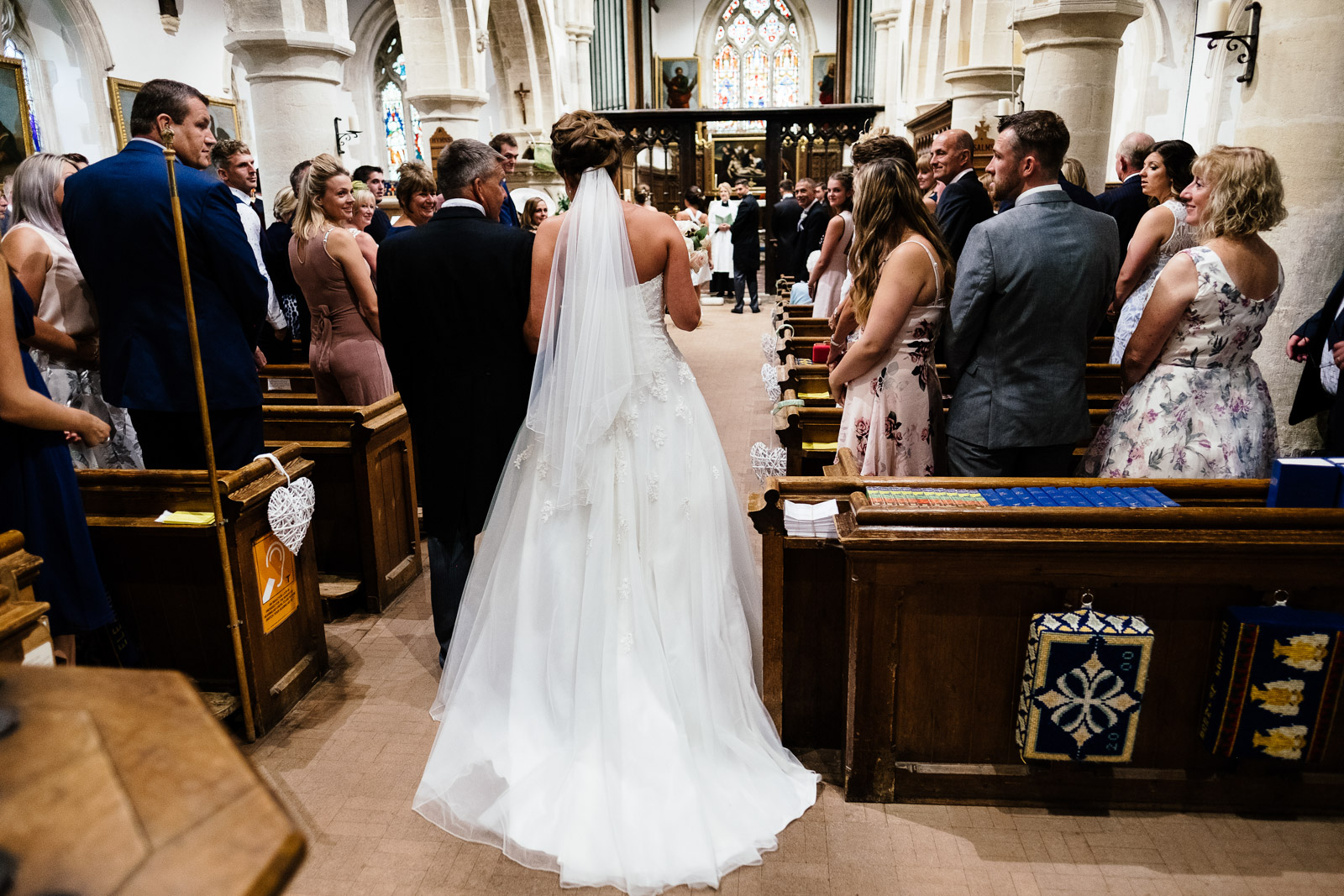 A bride enters Chinnor church with her father. Photo by Sam and Steve Photography