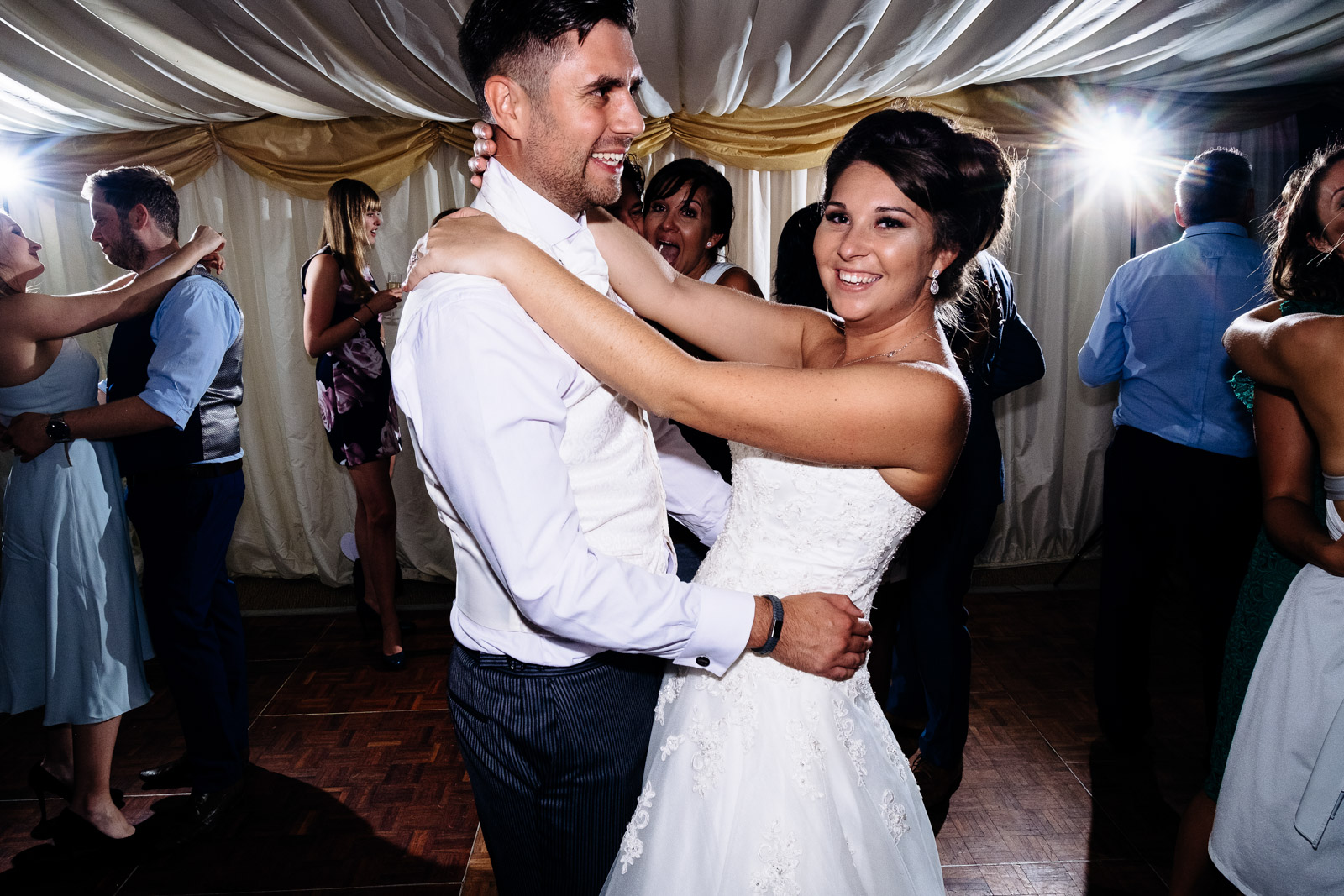 A bride and groom dancing at Notley Tythe Barn Wedding Venue. 